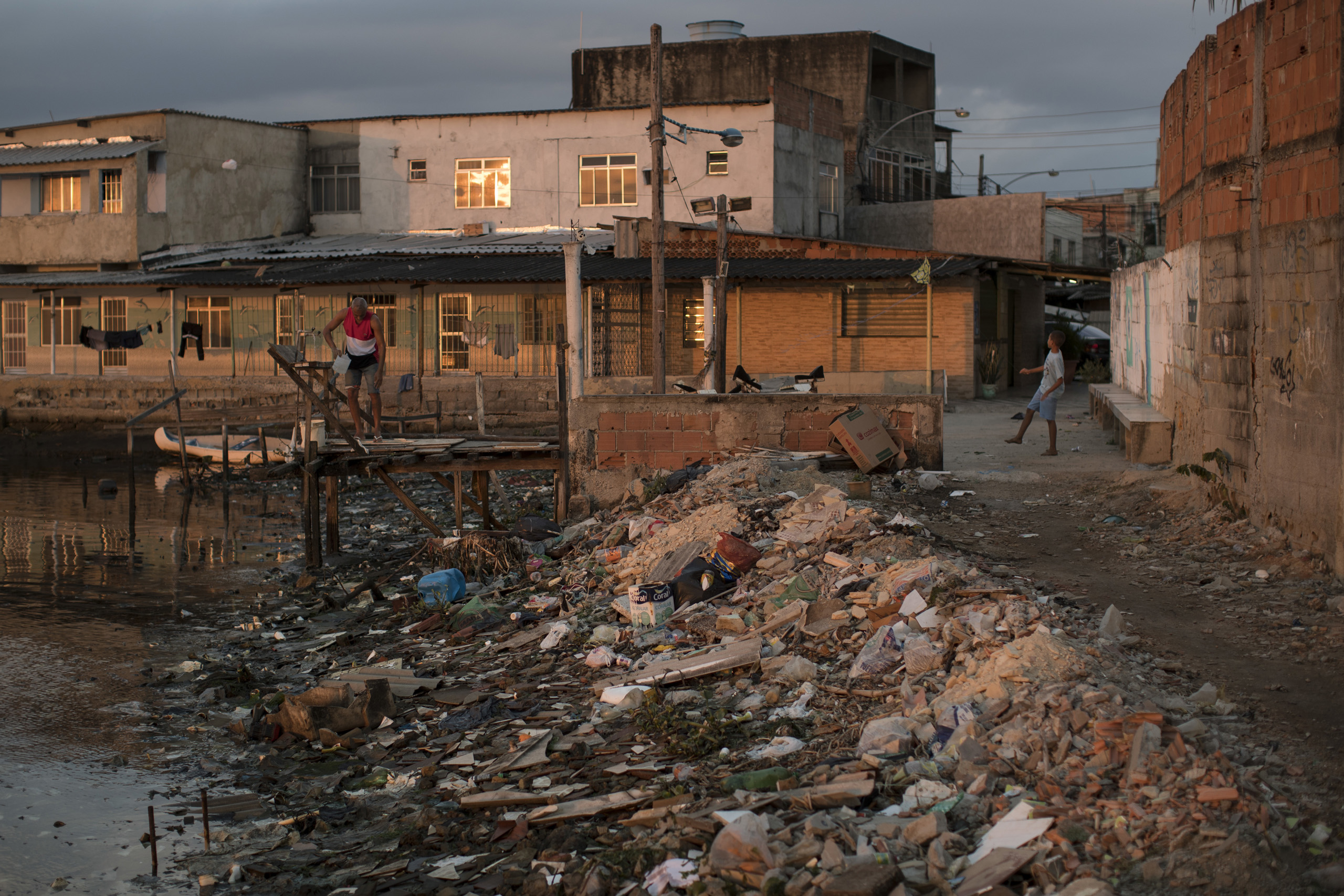 Houses sit next to a heavily polluted shore in Guanabara bay in Rio de Janeiro on July 30, 2016.