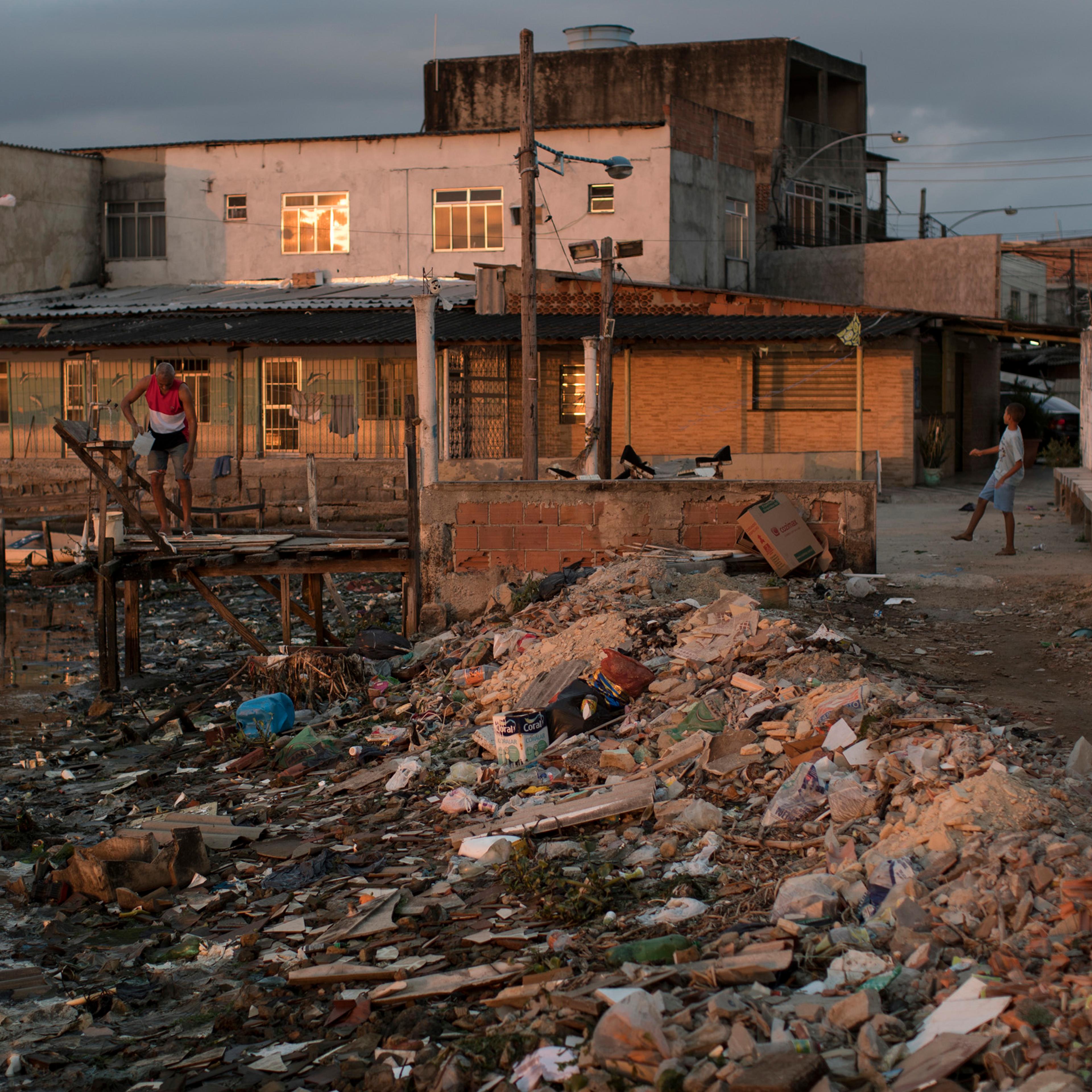 Houses sit next to a heavily polluted shore in Guanabara bay in Rio de Janeiro on July 30, 2016.