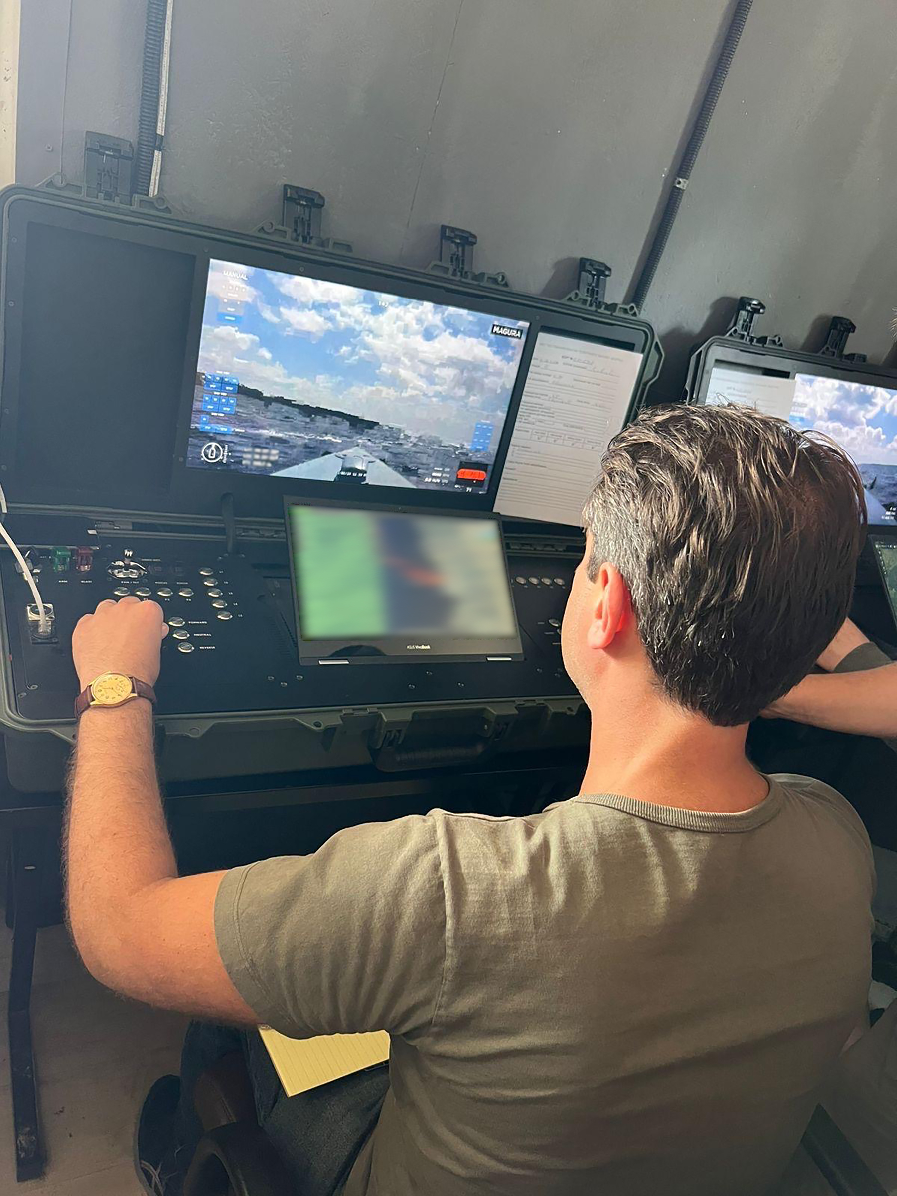 TIME correspondent Simon Shuster tries out the controls of a Magura naval drone at a clandestine military base in Ukraine.
