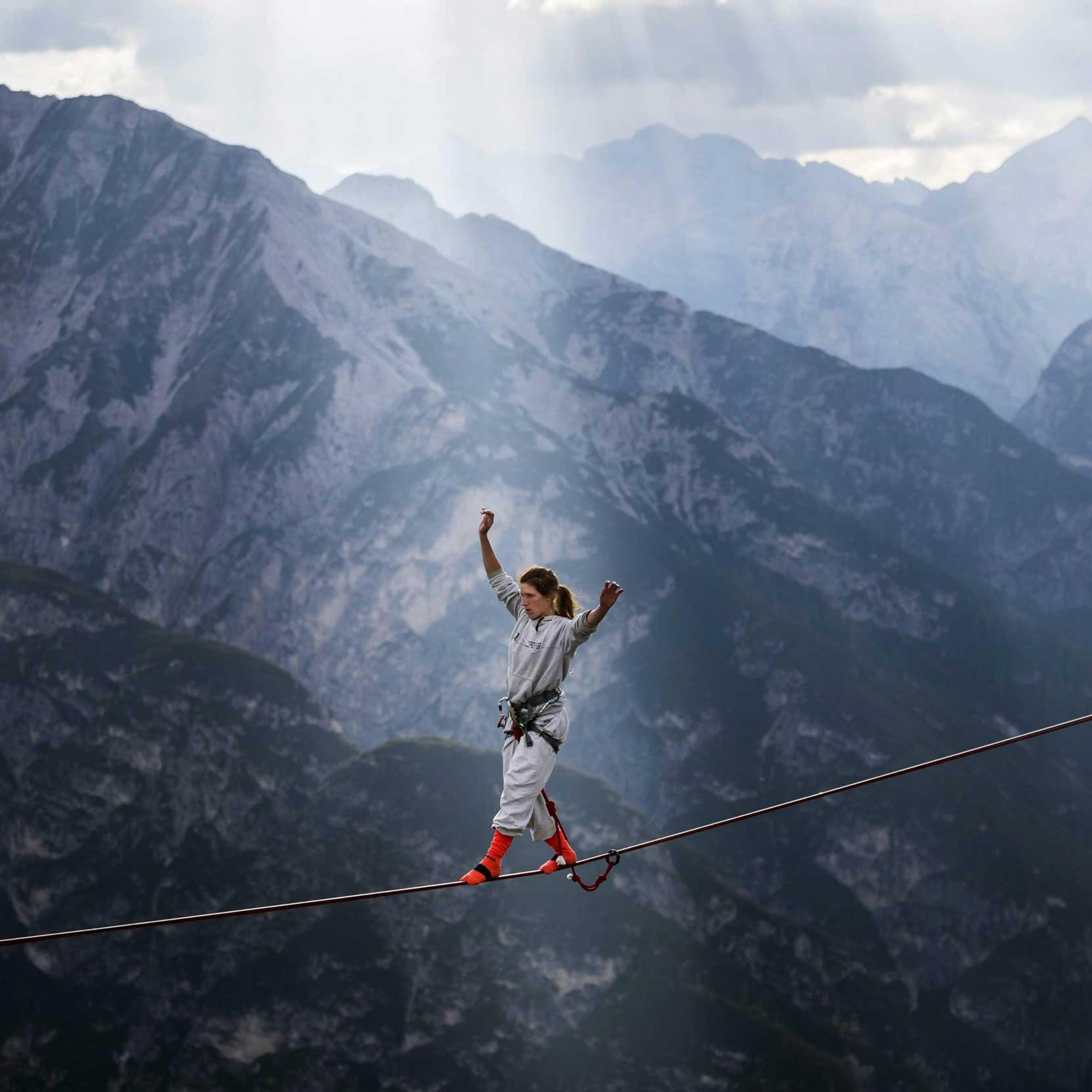 An extreme athlete balancing on a webbing during the International Highline Meeting in Monte Piana, near Misurina, in the northern Italian Alps, Italy on Sept. 11, 2014.