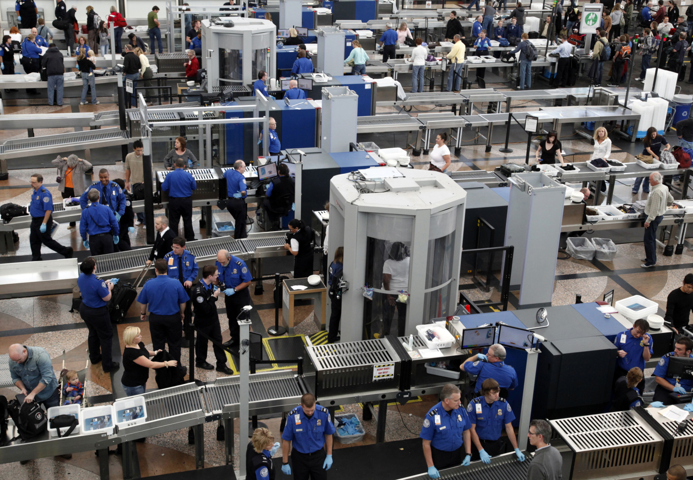 TSA workers carry out security checks at Denver International Airport, the day before the Thanksgiving holiday in Denver