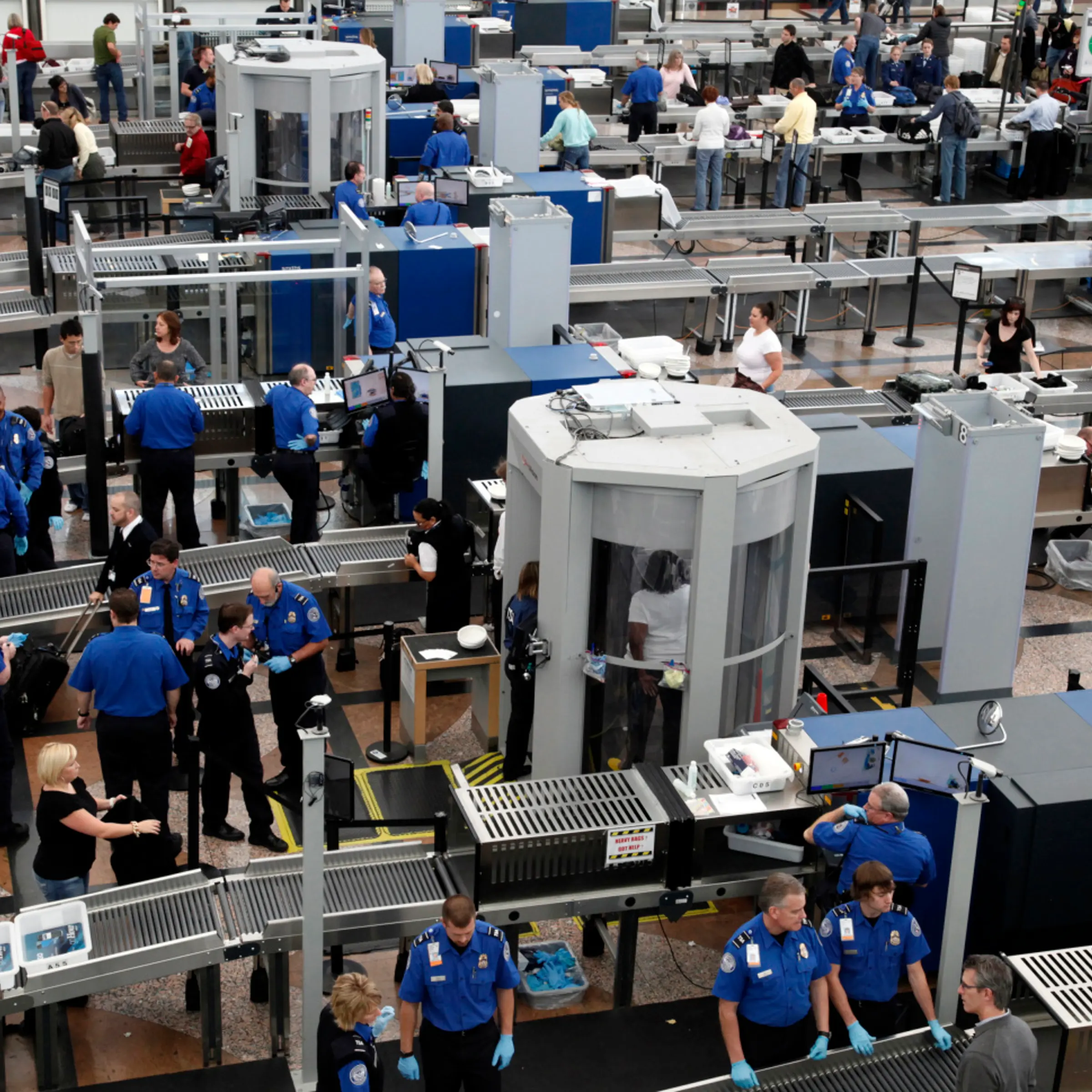 TSA workers carry out security checks at Denver International Airport, the day before the Thanksgiving holiday in Denver