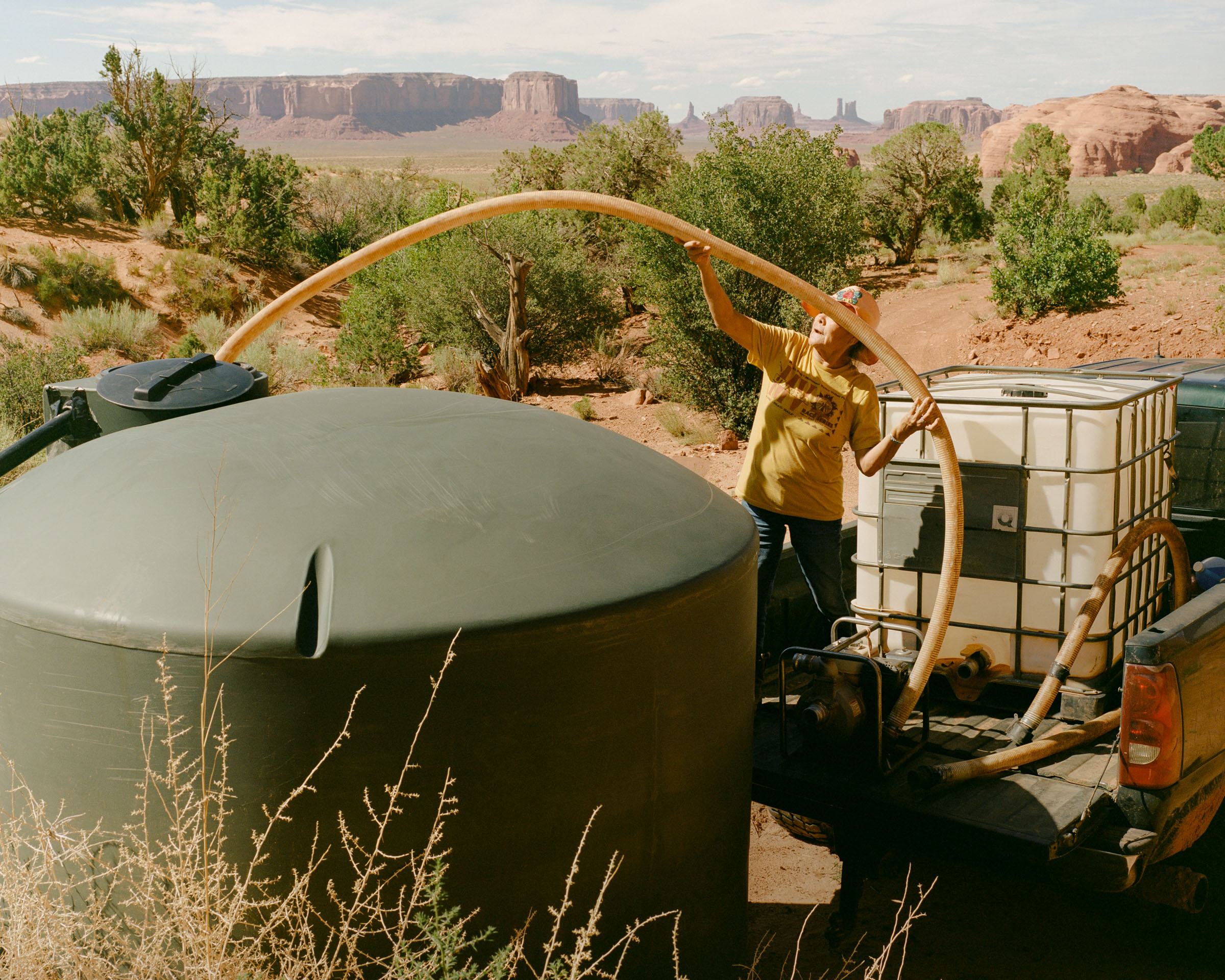 Effie Yazzie pulls into her yard with a full load of water during a long day of making multiple trips to fill the animal troughs and the barrels that surround her home. 