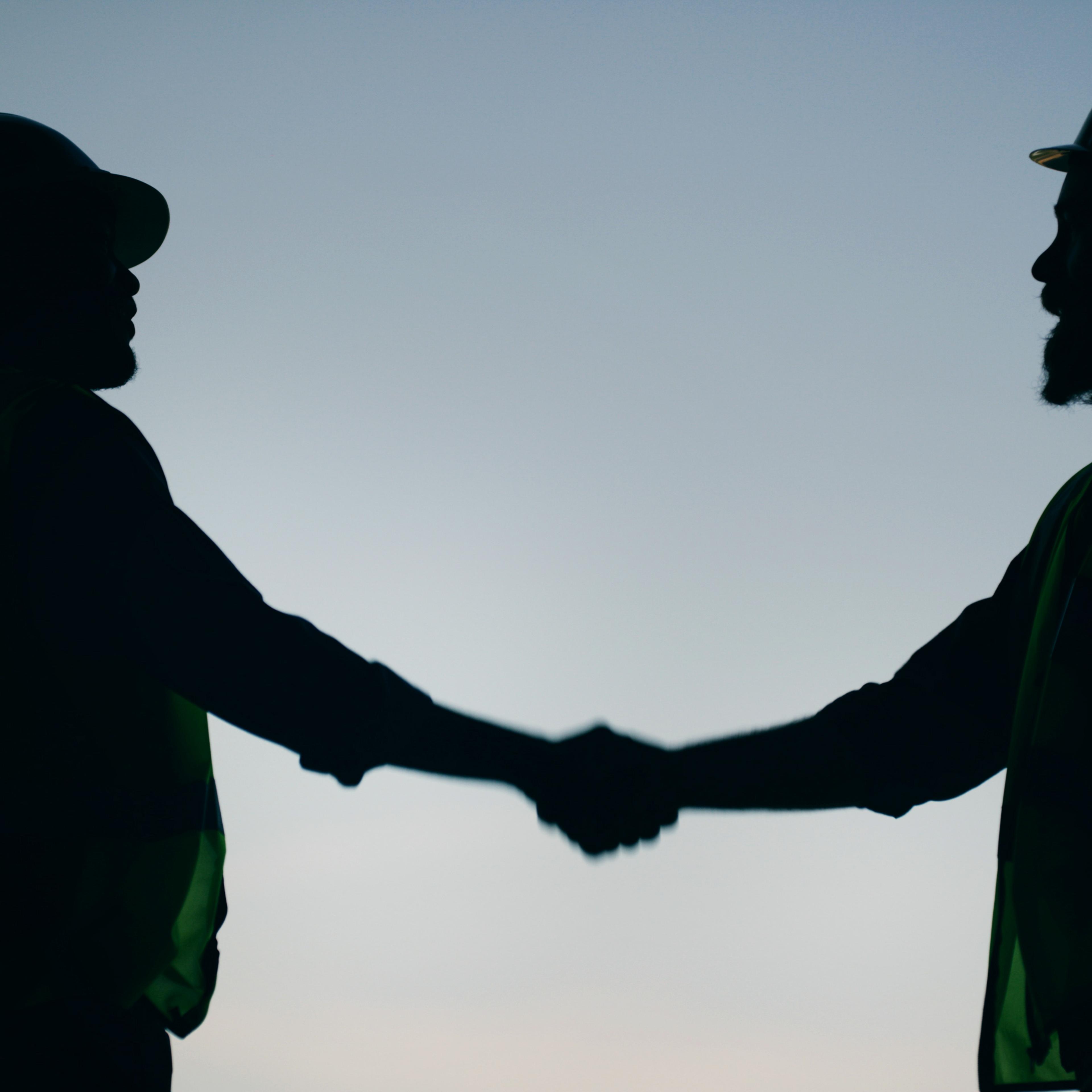 Two people shake hands
