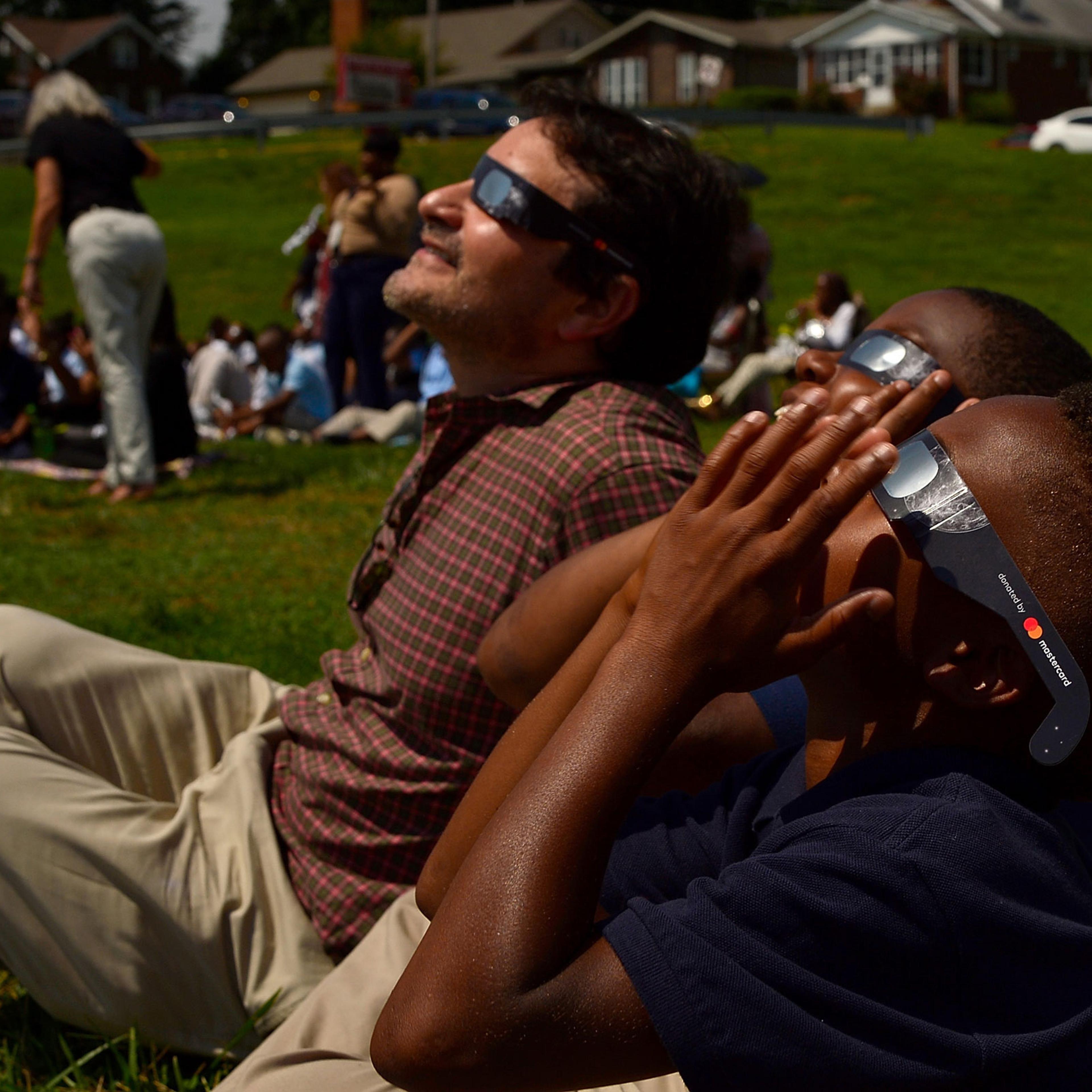 Students view the solar eclipse in St. Louis, on August 21, 2017.