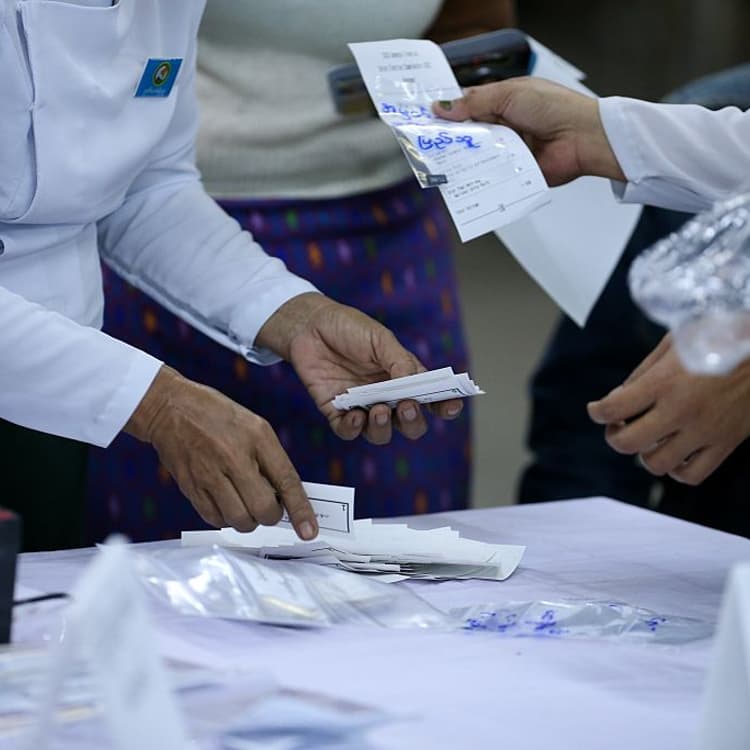 Officials of the Union Election Commission work during the second phase of the general election at a polling station in Yangon, Myanmar, on Jan. 11, 2026.