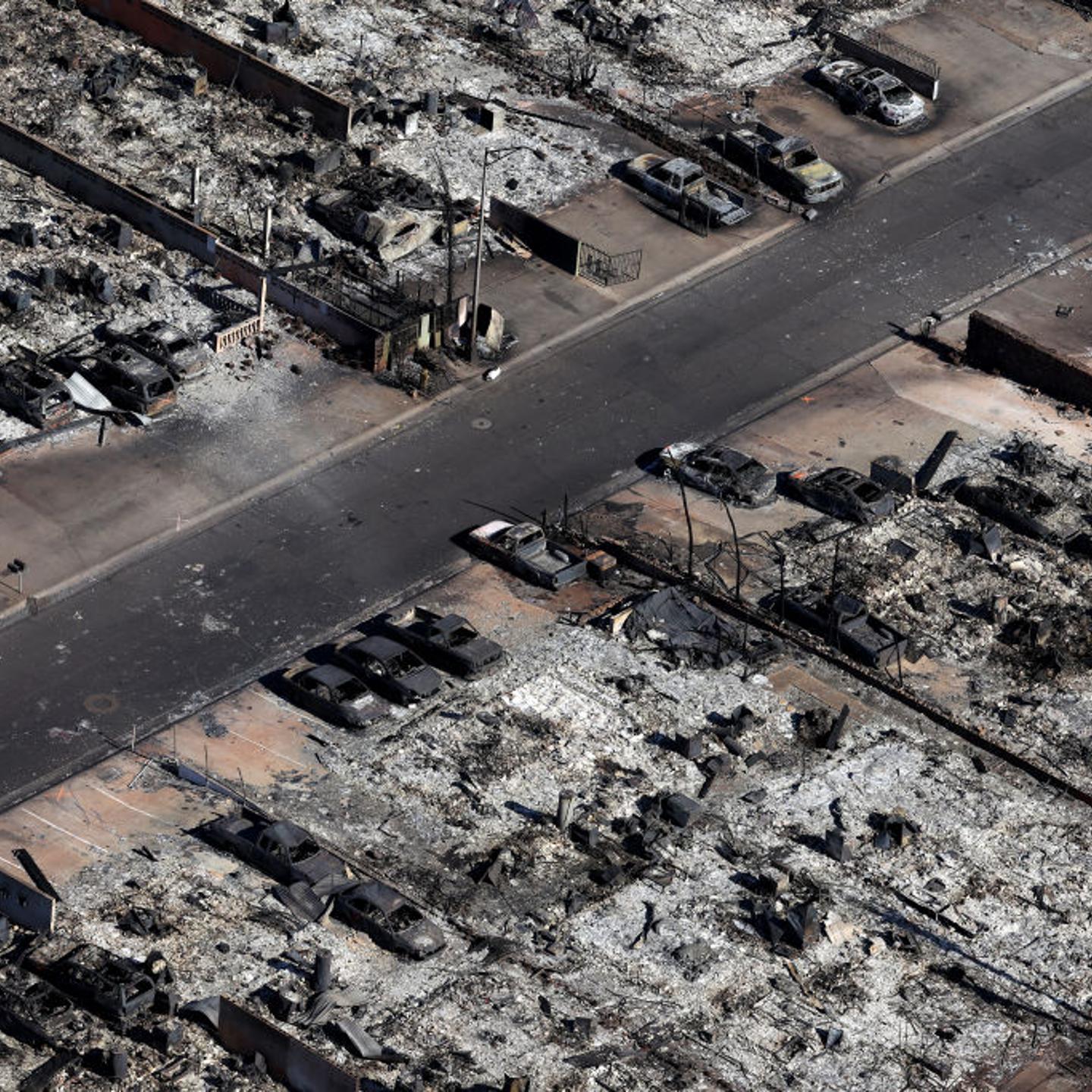 Burned cars sit in front of homes destroyed by a wildfire on August 11, 2023 in Lahaina, Hawaii. Dozens of people were killed and thousands were displaced.