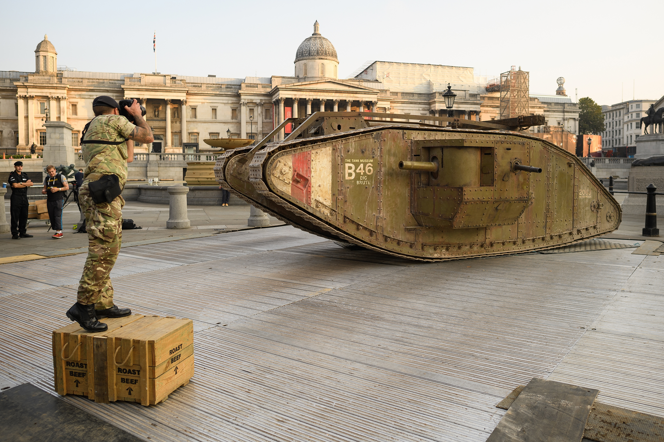 LONDON, ENGLAND - SEPTEMBER 15: An Army photographer takes a photograph of a replica British Mark IV tank as it is displayed in Trafalgar Square on September 15, 2016 in London, England. The tank is in place to mark 100 years to the day since they were f
