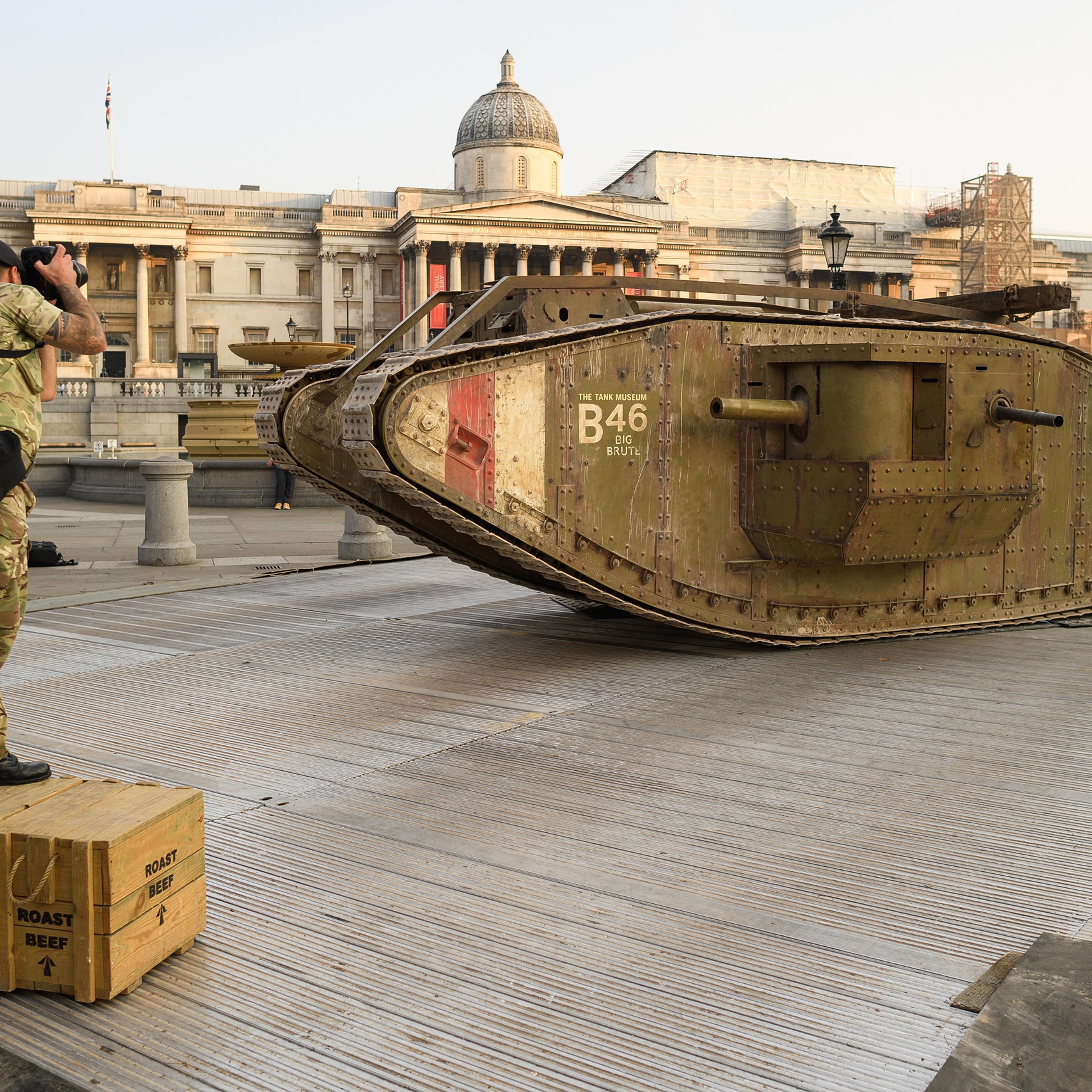 LONDON, ENGLAND - SEPTEMBER 15: An Army photographer takes a photograph of a replica British Mark IV tank as it is displayed in Trafalgar Square on September 15, 2016 in London, England. The tank is in place to mark 100 years to the day since they were f