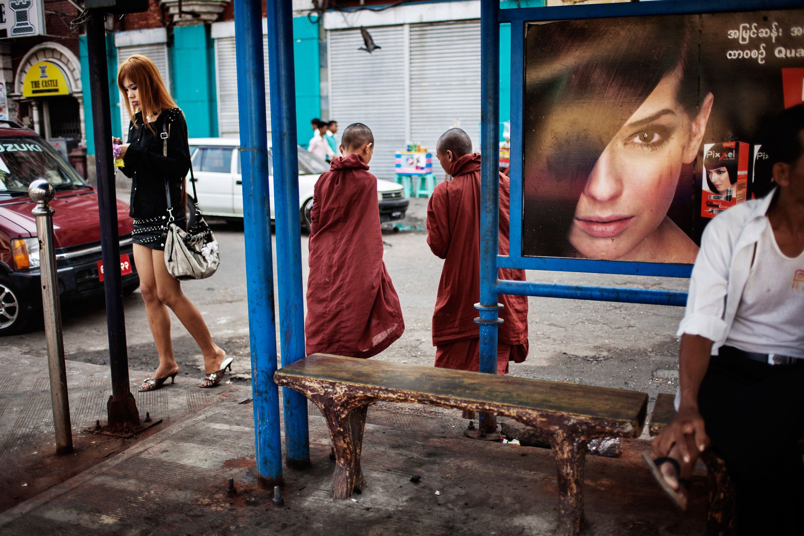 The “micro-mini” skirt appears on Rangoon streets, where the sarong-like longyi has been increasingly replaced by jeans and other Western-style clothes. From <i> Burmese Spring</i>, a series looking at Burma as it anticipated parliamentary elections in April 2012, the first since the passage of reforms, including the end of the ban on the opposition party, the National League for Democracy. 
