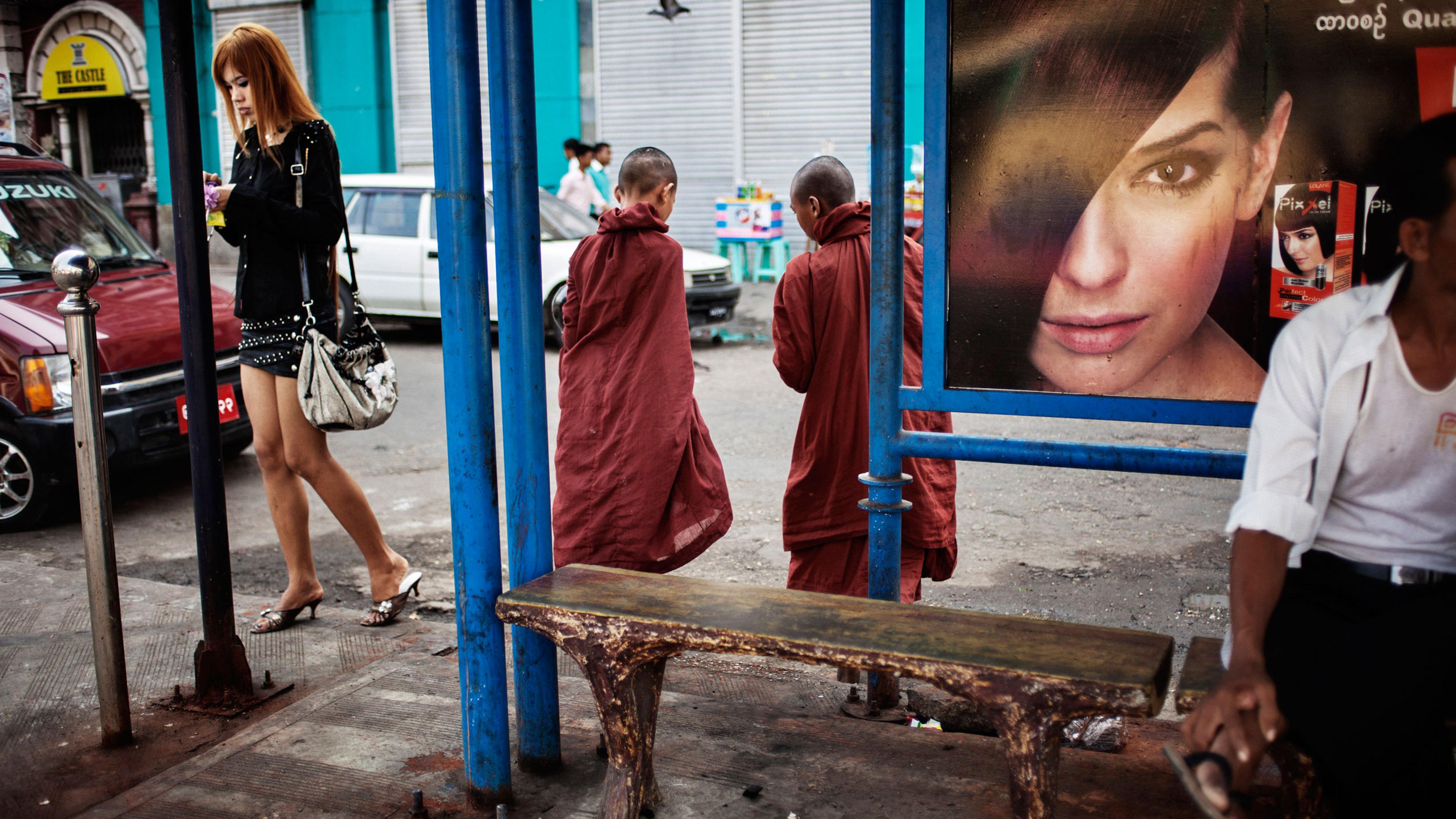 The “micro-mini” skirt appears on Rangoon streets, where the sarong-like longyi has been increasingly replaced by jeans and other Western-style clothes. From <i> Burmese Spring</i>, a series looking at Burma as it anticipated parliamentary elections in April 2012, the first since the passage of reforms, including the end of the ban on the opposition party, the National League for Democracy.