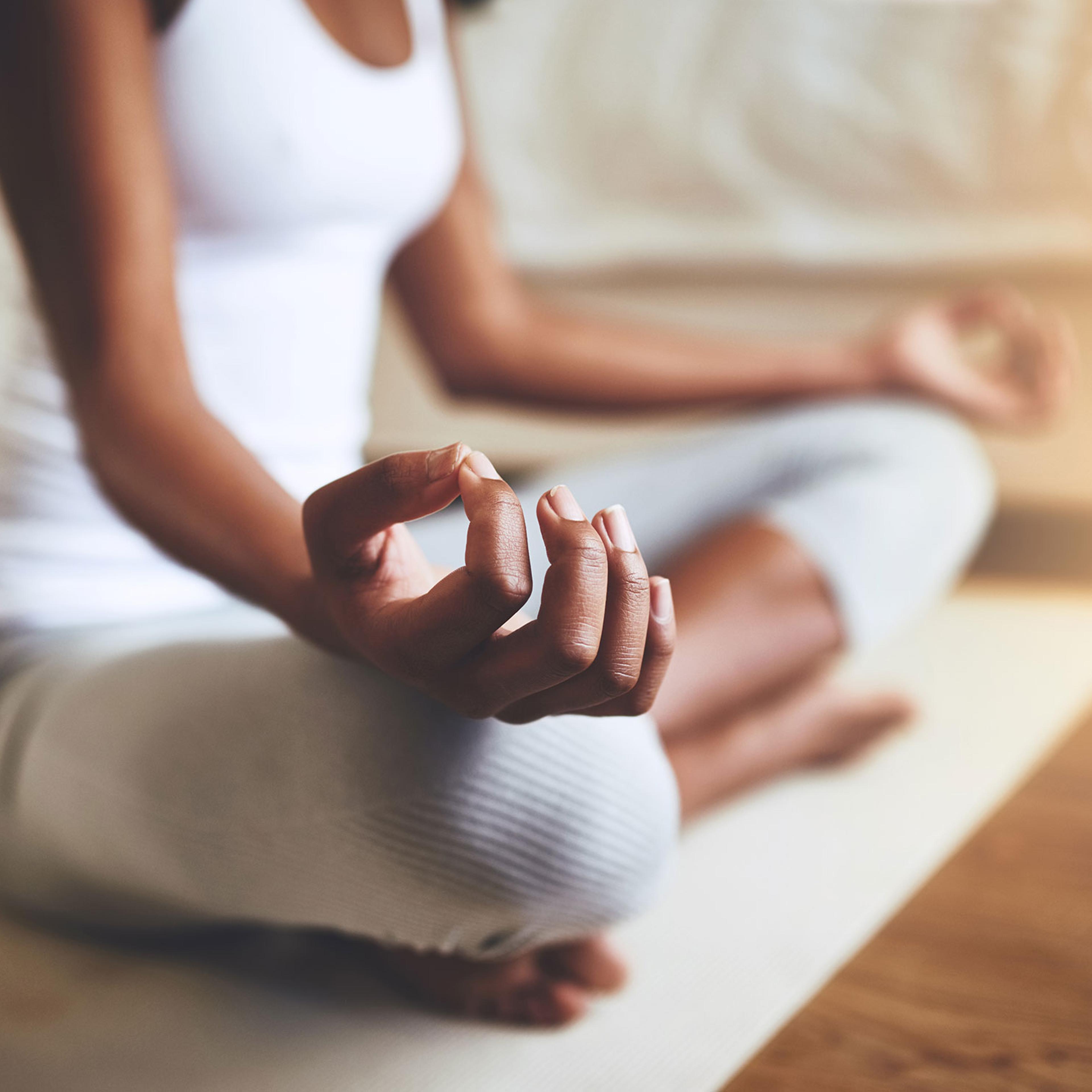 Cropped shot of an unrecognizable young woman practicing yoga indoors