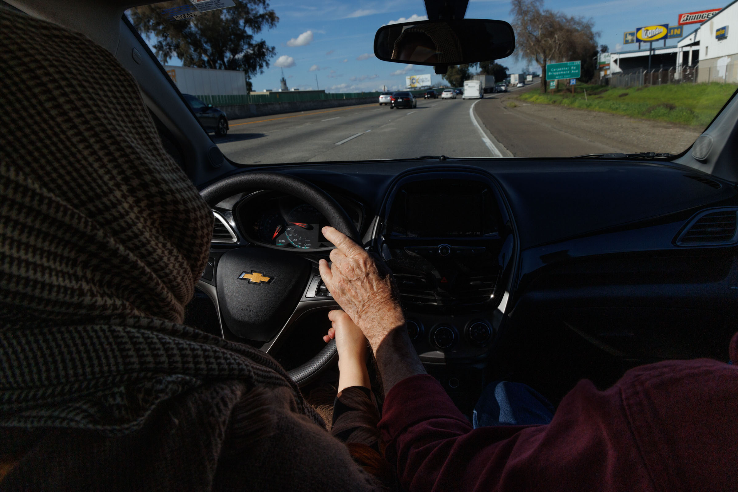 Gil Howard, a retired professor who happened upon a second career as a driving instructor, helps Khalida Noori to stay centered in a highway lane, in Modesto, Calif., Feb. 21, 2024. (Rachel Bujalski/The New York Times)