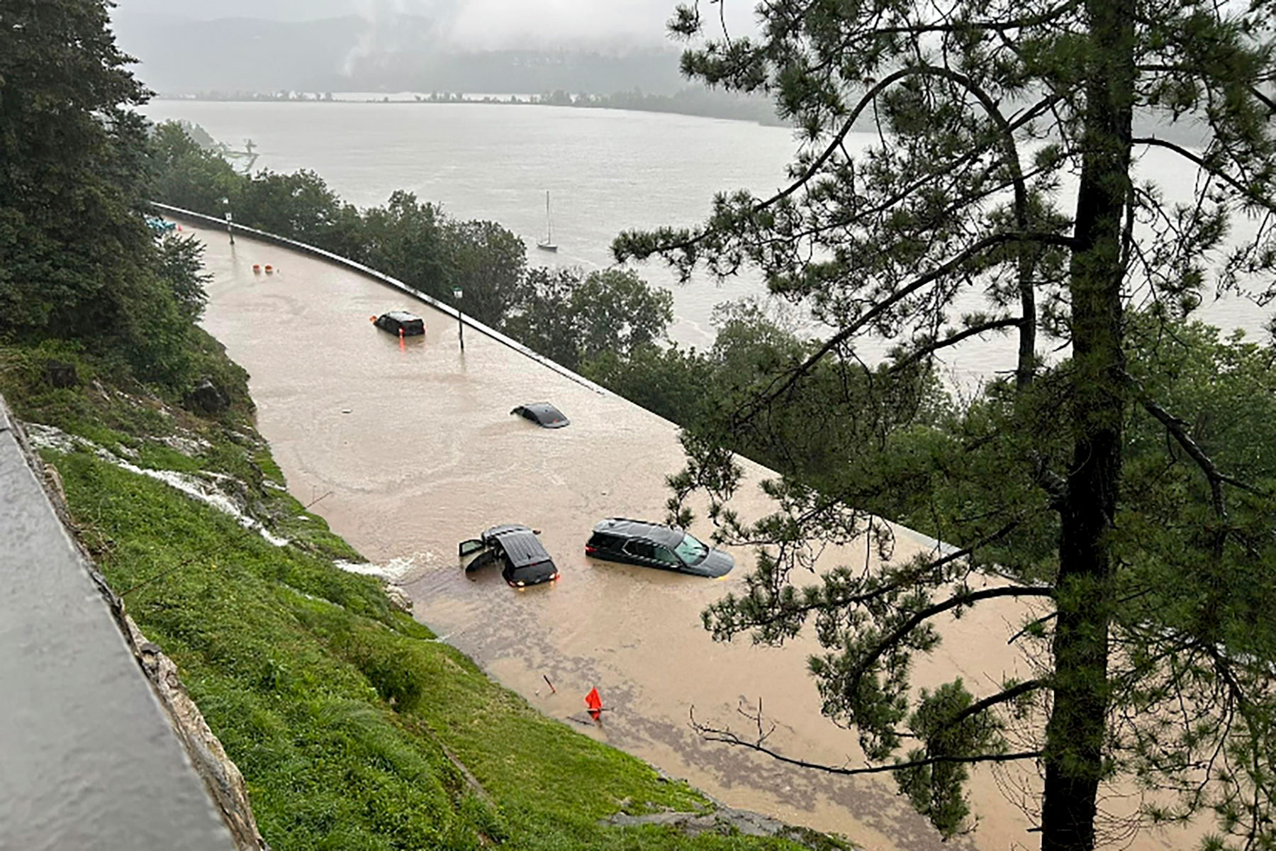 Cars sit stranded in standing flood water along Thayer Road on the campus of the United States Military Academy