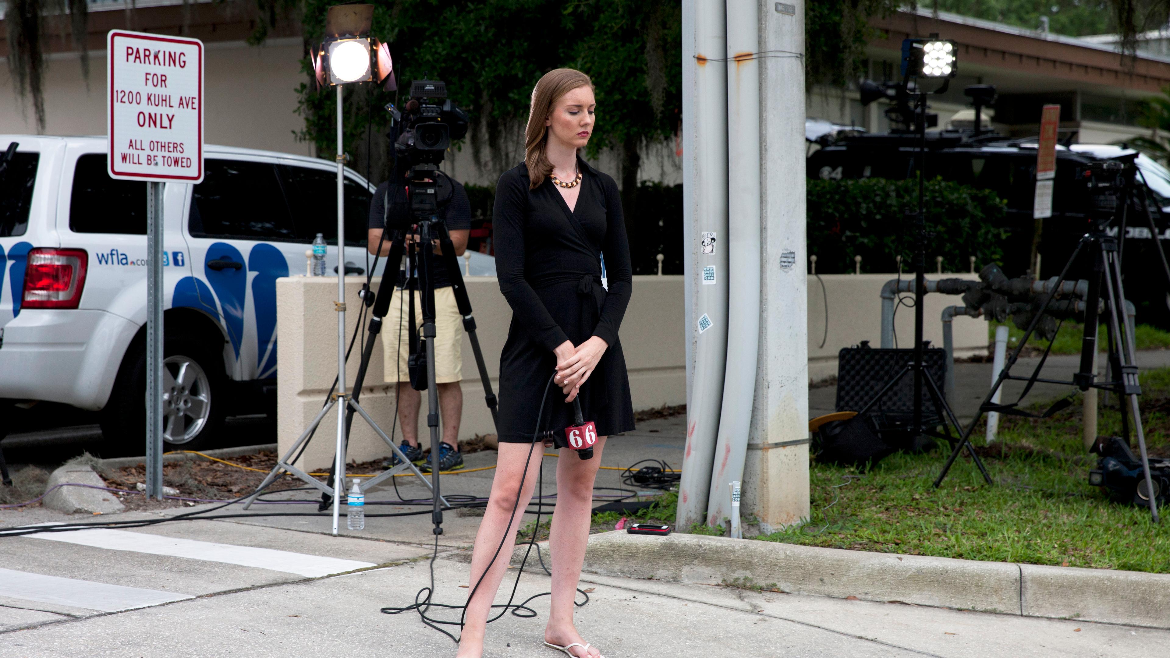 A reporter pauses at the Hampton Inn where relatives of victims gather for information in Orlando, Fla., on June, 12, 2016.