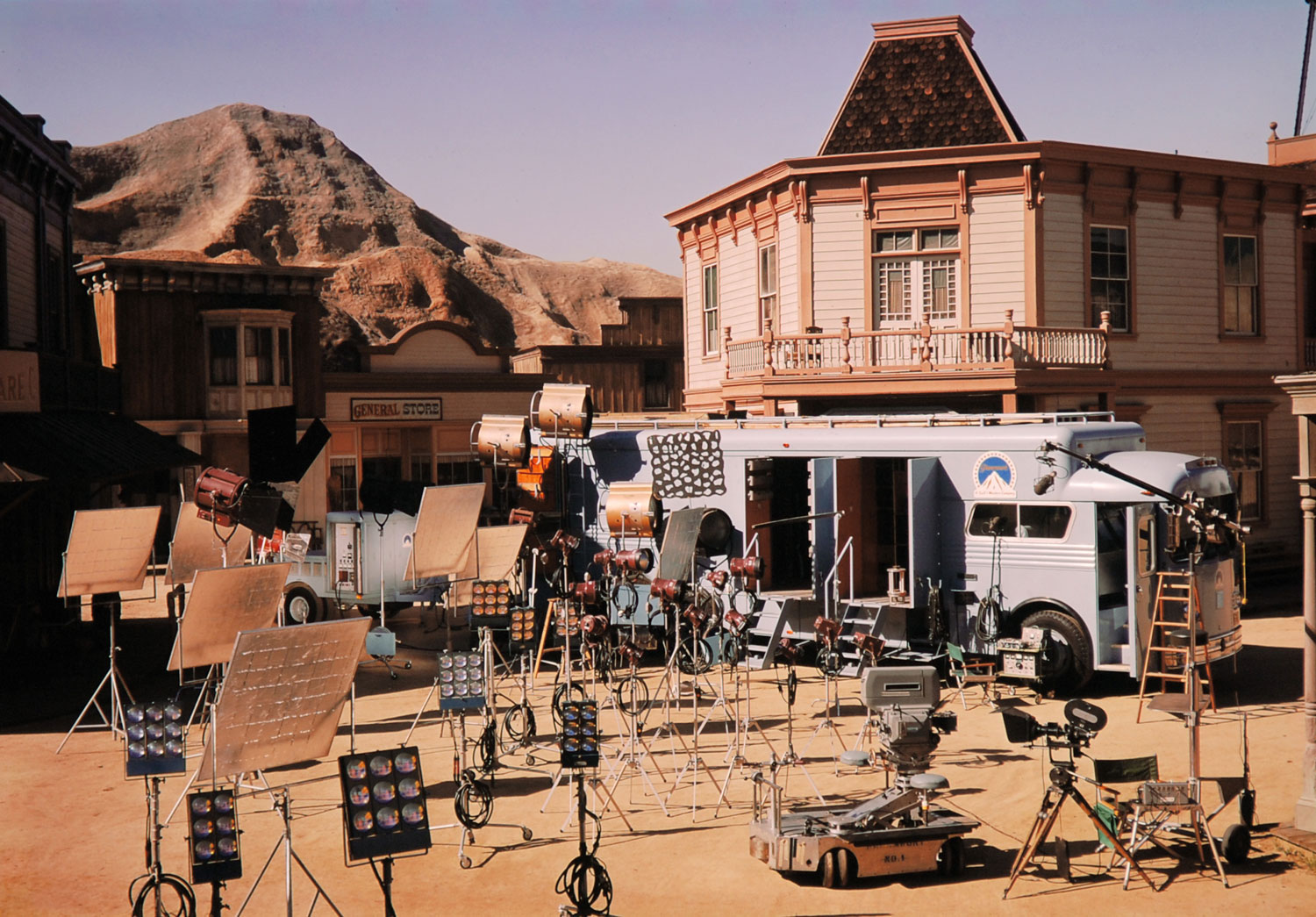 The scene of countless cowboy shoot-outs, a phony Western town drowses beneath a painted sky on the Paramount back lot.