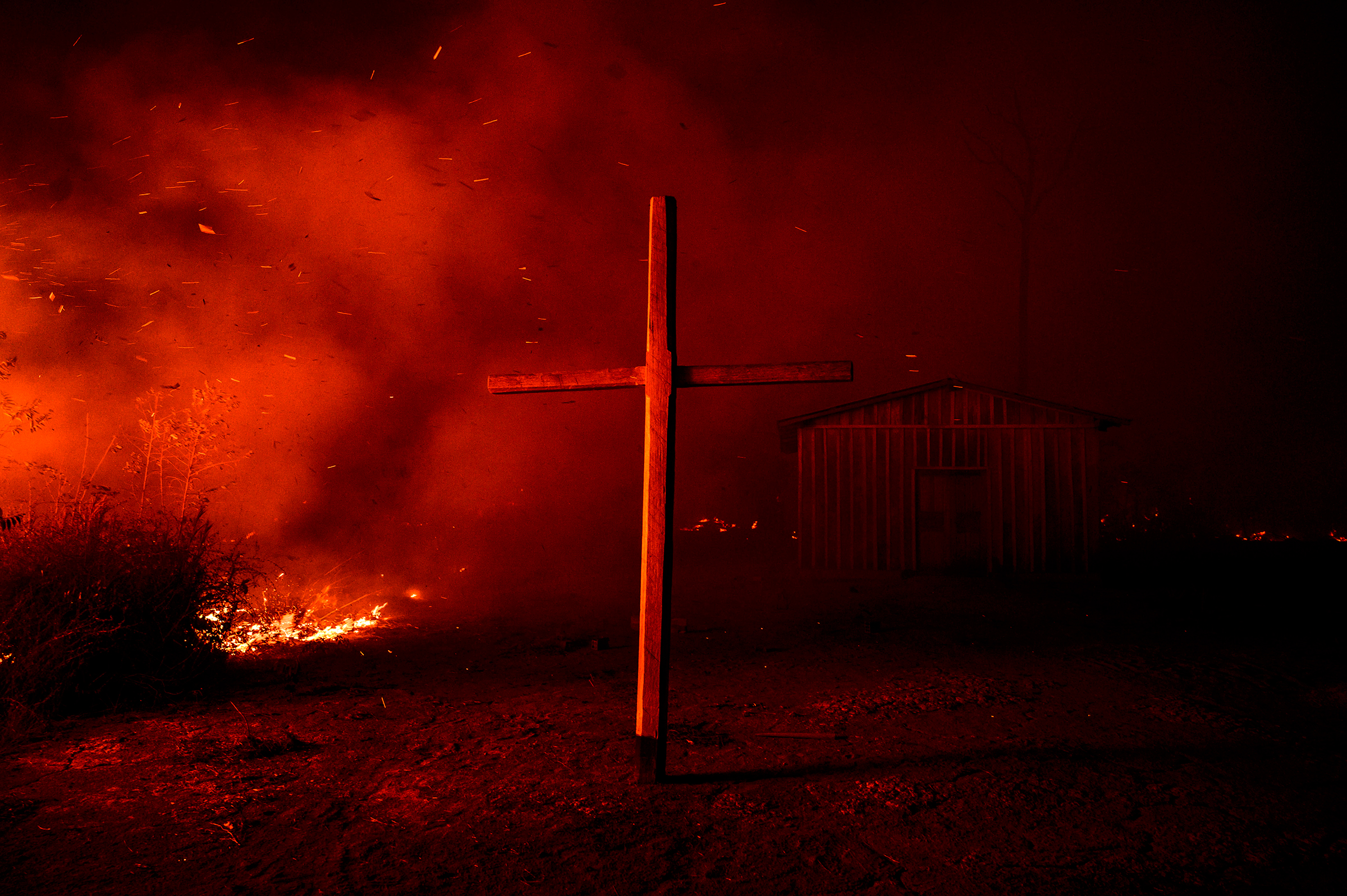 A church is enveloped in smoke from nearby flames in the region of Vila Nova Samuel, near the Jacundá National Forest, on Aug. 27.