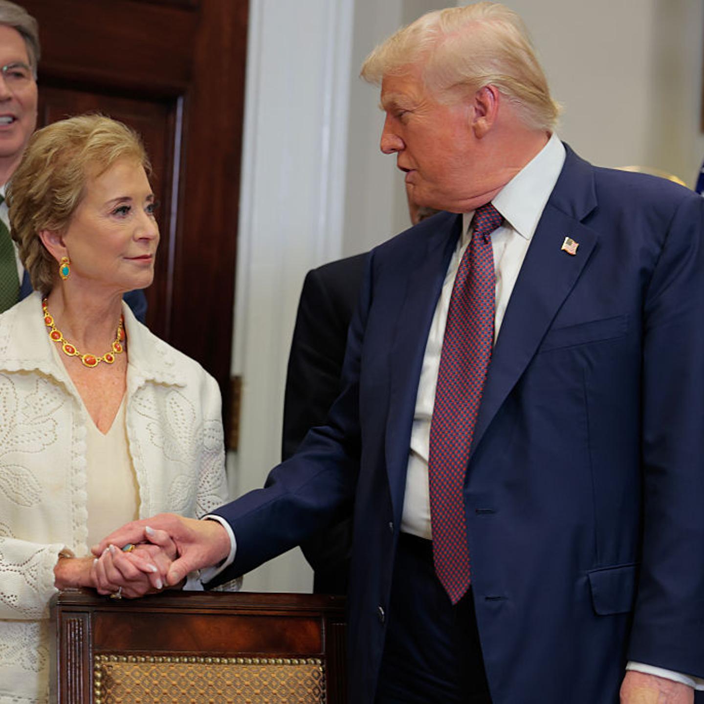 President Donald Trump speaks with Secretary of Education Linda McMahon