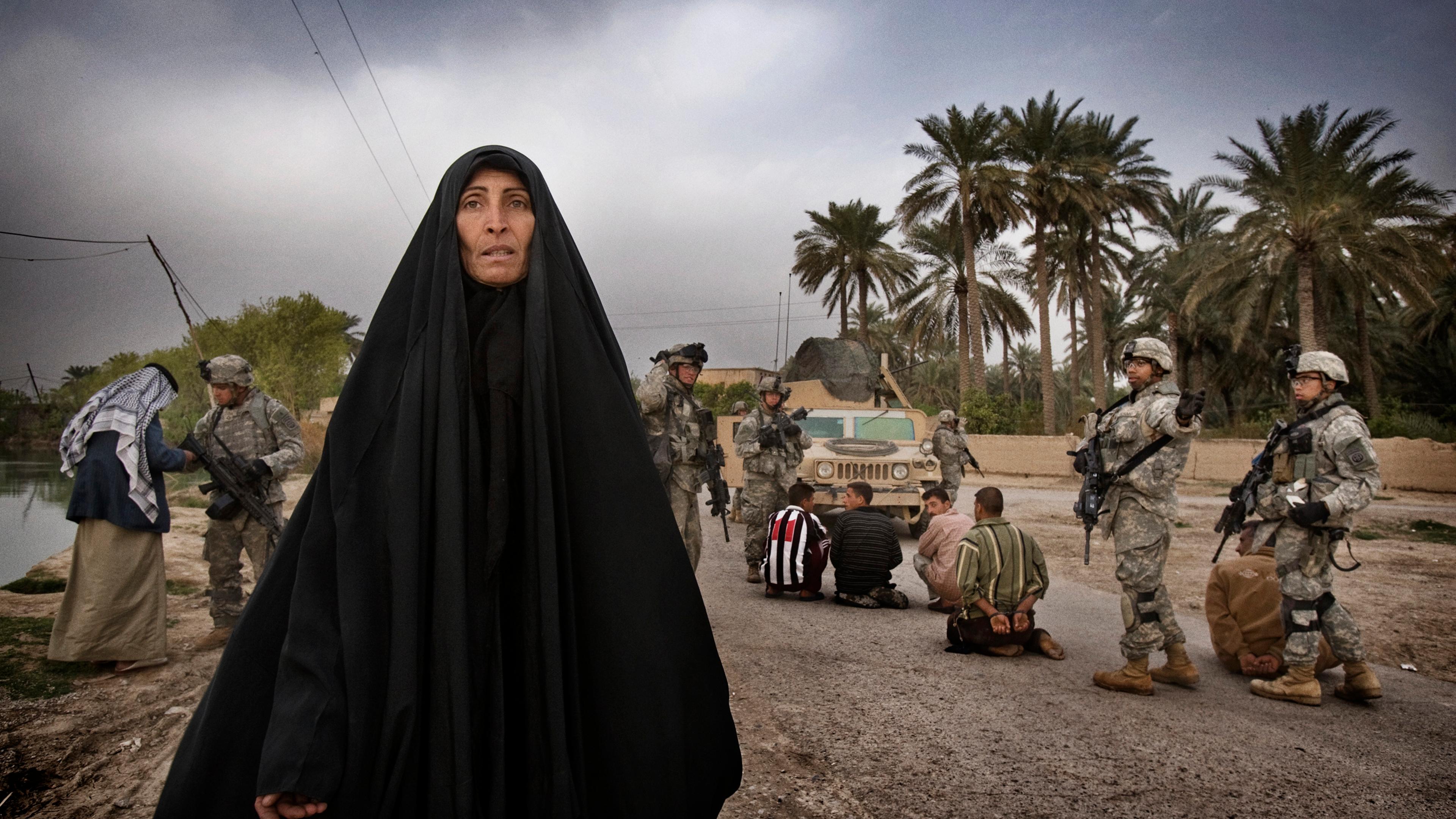 U.S. soldiers from A Troop 5th Squadron 73rd Cavalry detain suspected insurgent sympathizers after killing a militant caught laying a roadside bomb on the outskirts of Baquba. Women from the village begged for the release of the men as U.S. soldiers led