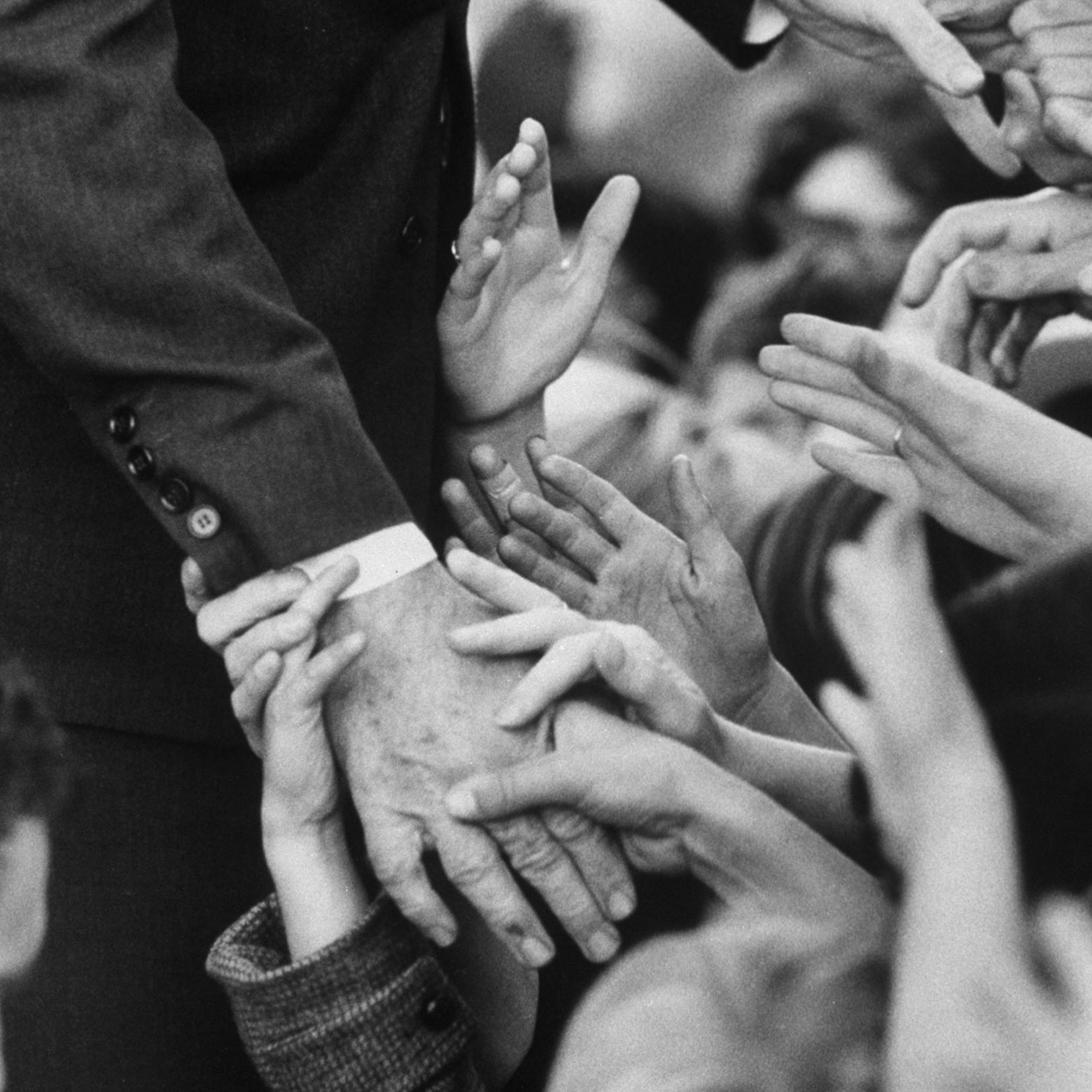 Sen. Robert F. Kennedy shakes hands with admirers in October 1966.