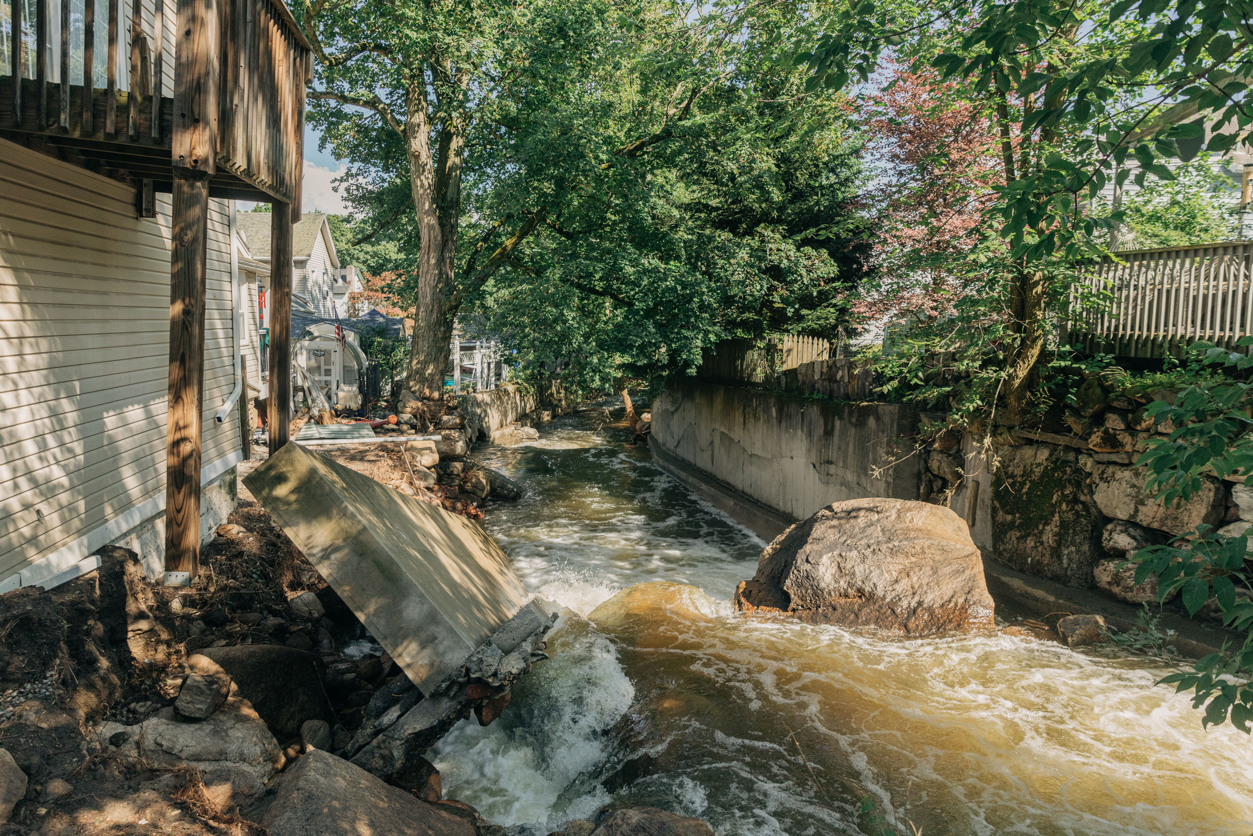 A damaged wall is seen on flooded water at Highland Fall in New York