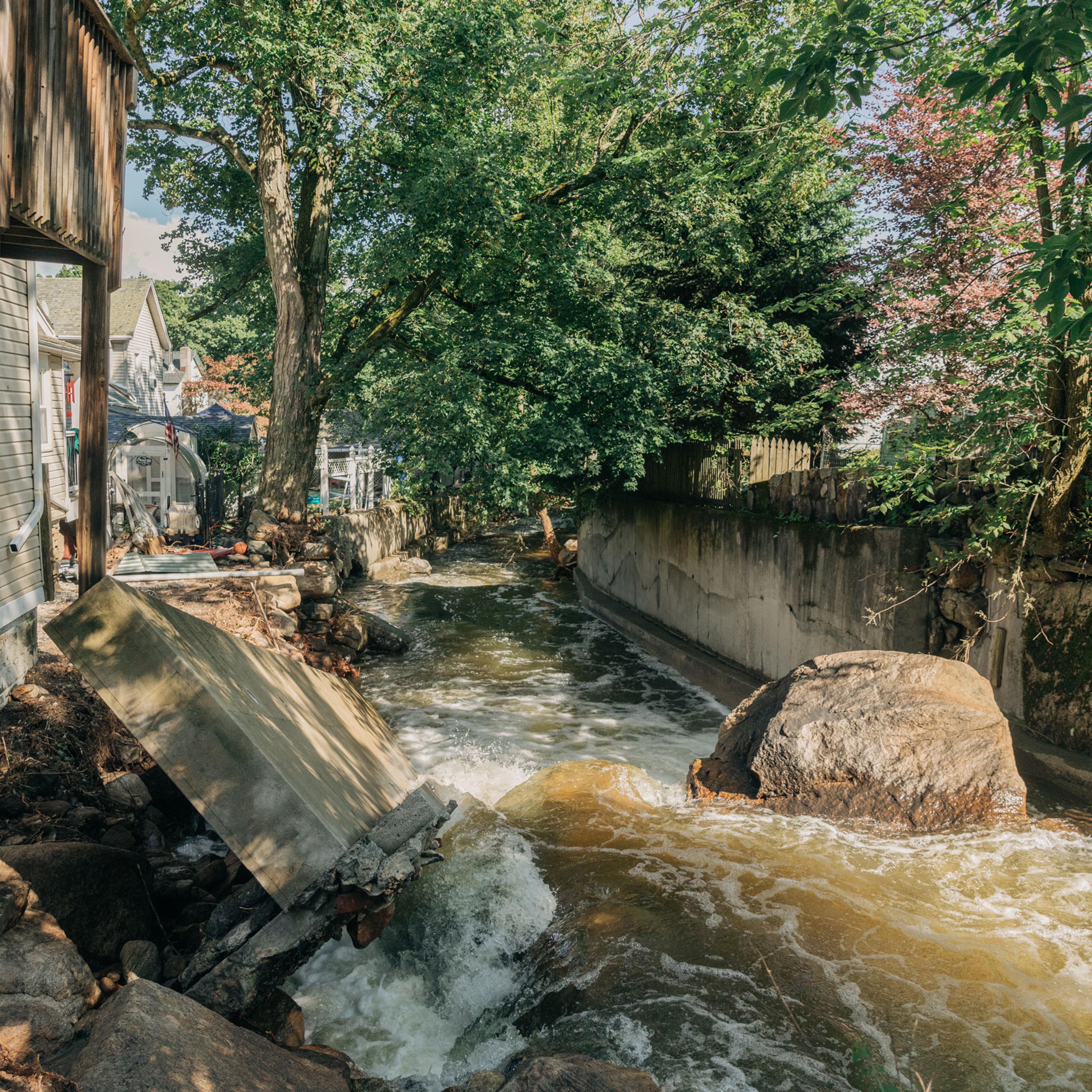 A damaged wall is seen on flooded water at Highland Fall in New York