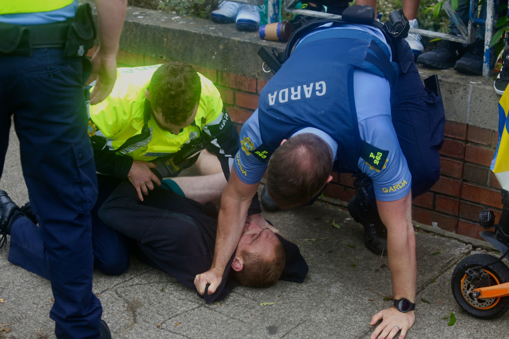 Ireland police department Gardai arrest an anti-immigration protester as demonstrators gather at a site designated for asylum seekers in Coolock, North Dublin, Ireland on July 15, 2024.