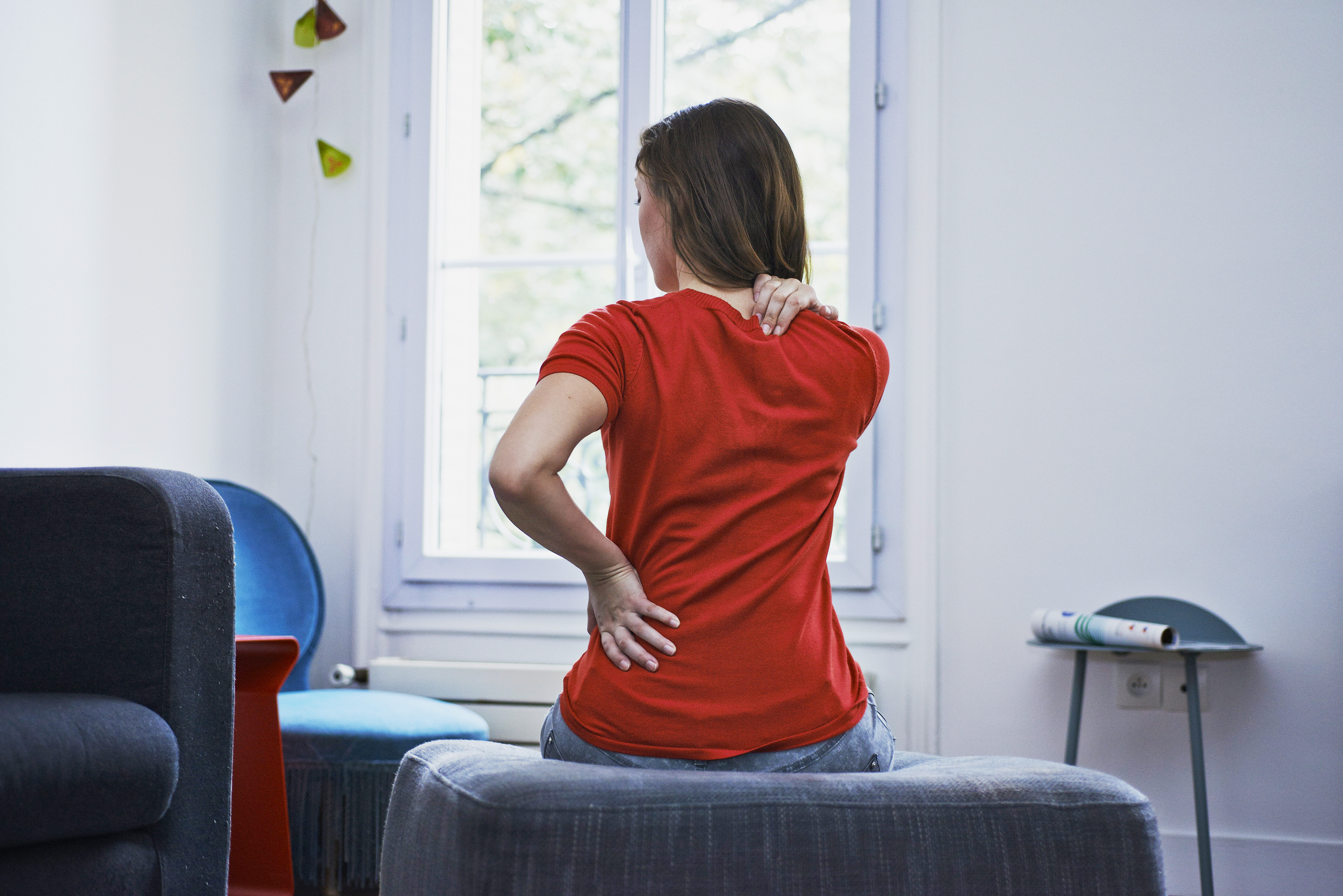 Woman suffering from back pain. France