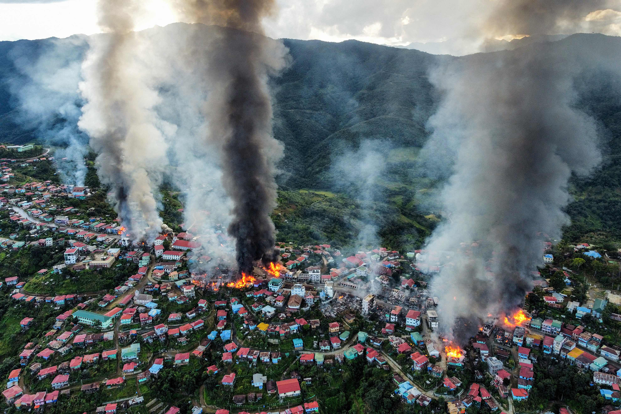 Smoke rises from fires in Thantlang, where many buildings have been destroyed by shelling from junta military troops in Chin State, Myanmar, Oct 29, 2021.