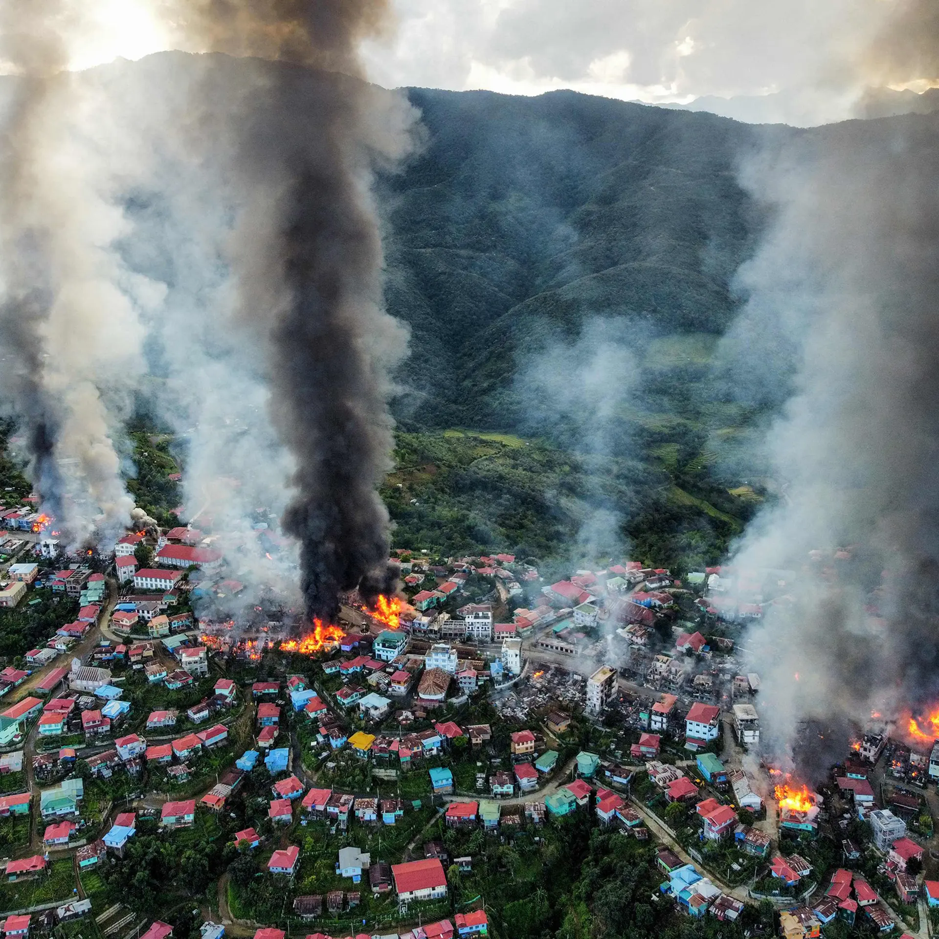 Smoke rises from fires in Thantlang, where many buildings have been destroyed by shelling from junta military troops in Chin State, Myanmar, Oct 29, 2021.