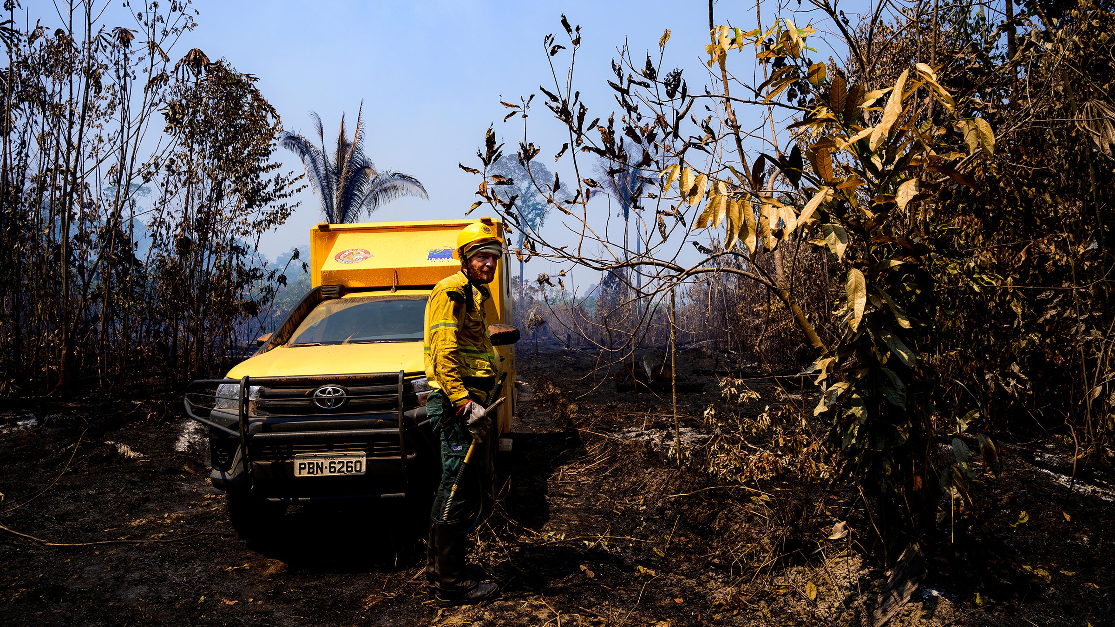 A worker and vehicle from Brazil's environmental agency, IBAMA, in a recently burned forest in the Vila Nova Samuel region on Aug. 28.