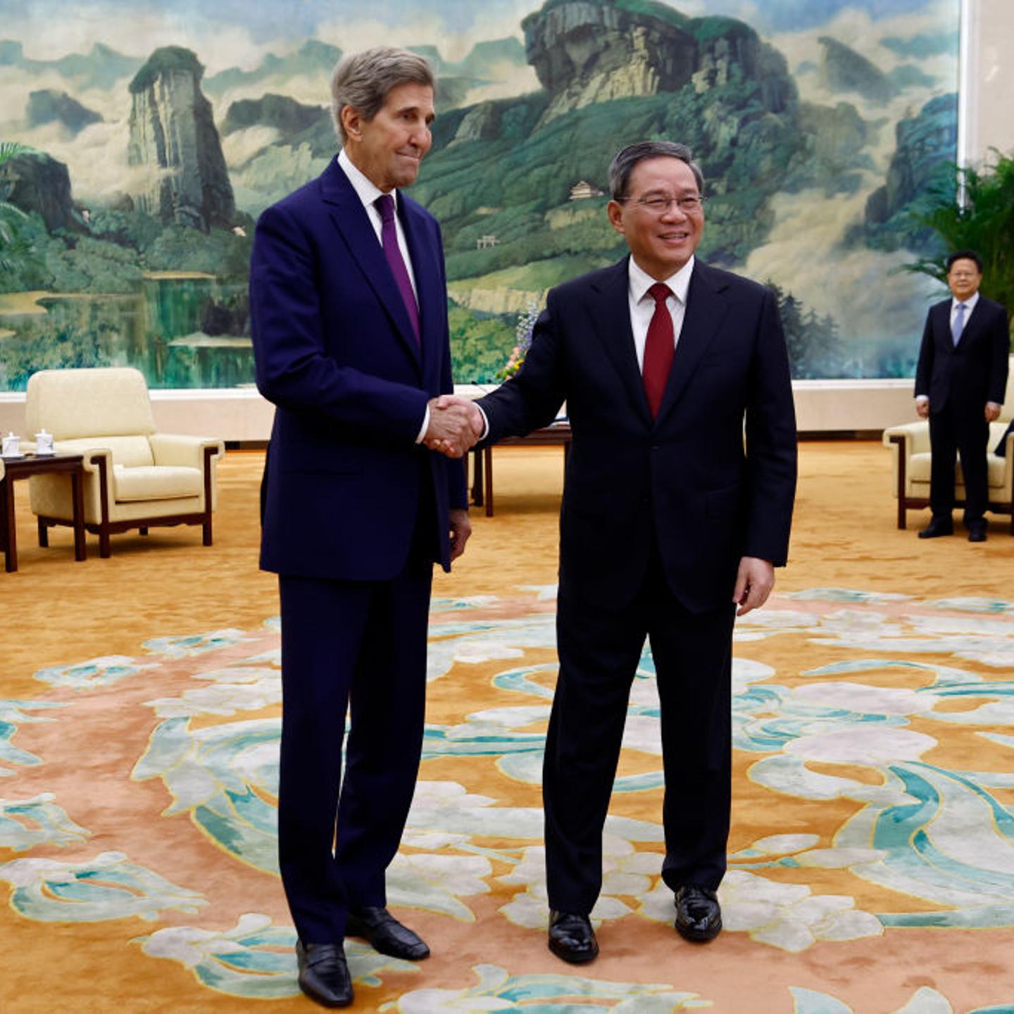 U.S. climate envoy John Kerry (L) is greeted by Chinese Premier Li Qiang before a meeting in the Great Hall of the People on July 18, 2023 in Beijing, China. Kerry is in Beijing to restart climate negotiations between the world's two biggest polluters.