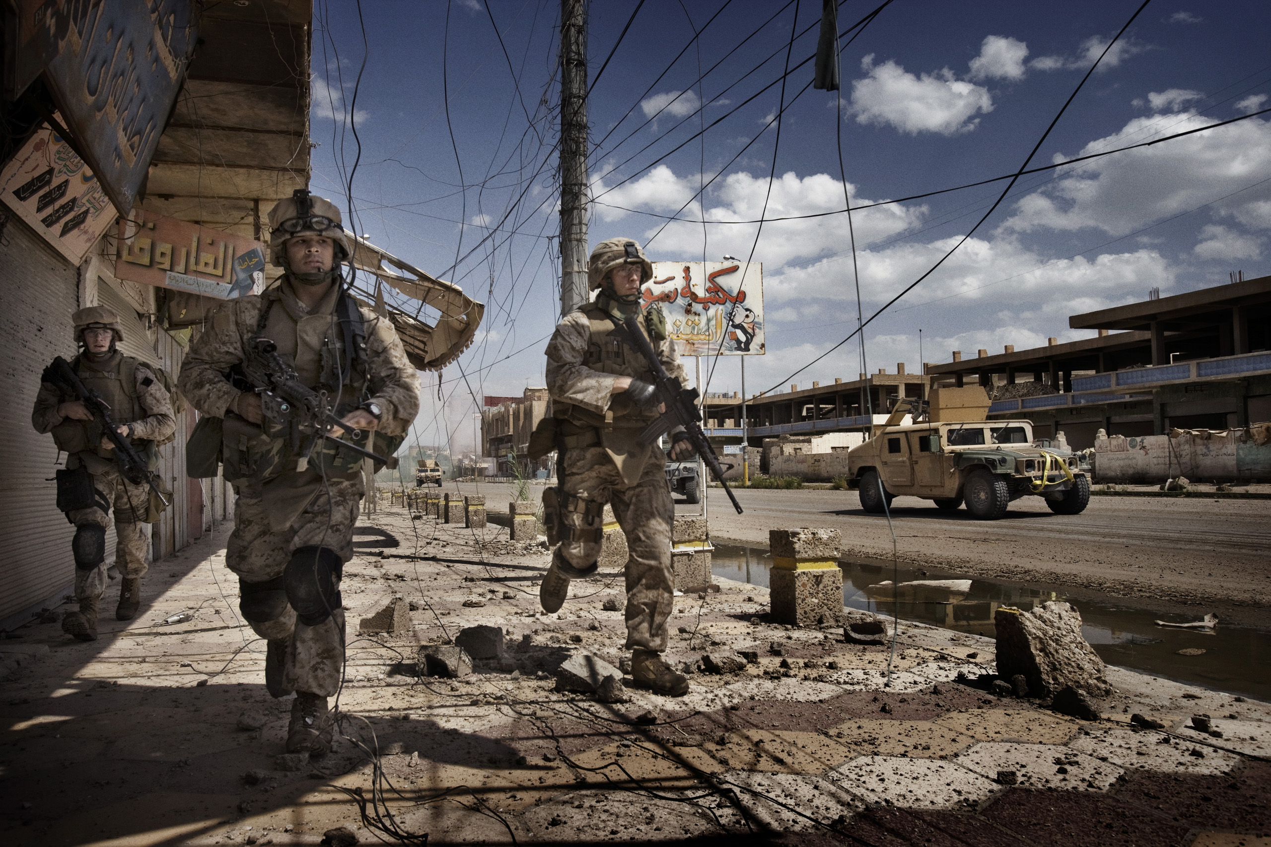 U.S. Marines from the 3rd Battalion, 8th Marine Regiment, Kilo company scan streets and surrounding buildings for insurgents during a patrol in Ramadi, Iraq, April 27, 2006.