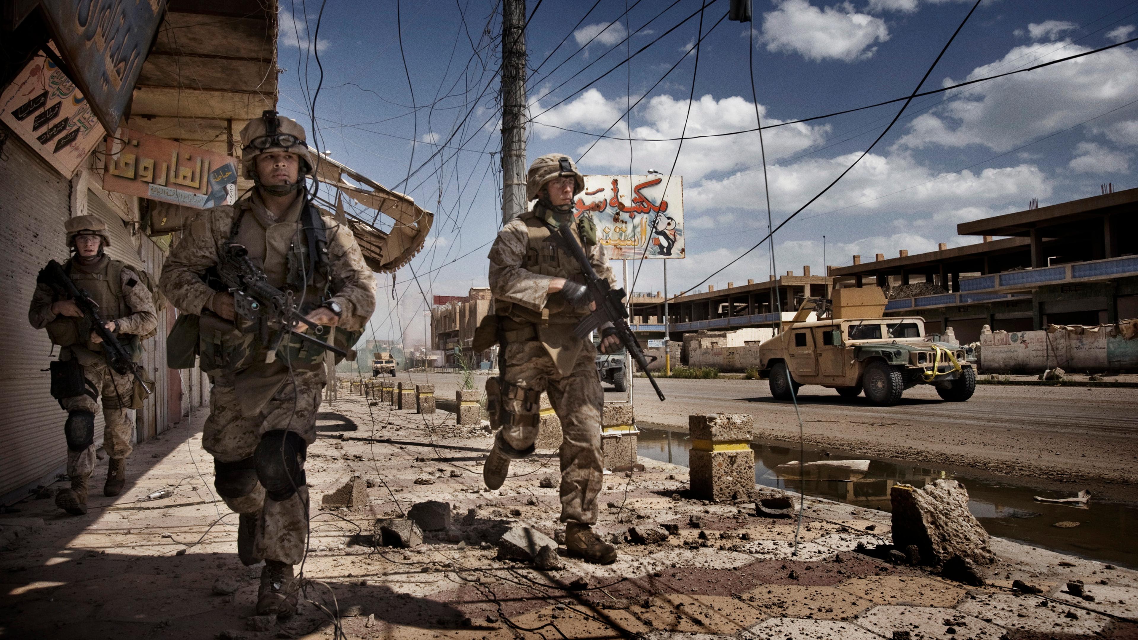 U.S. Marines from the 3rd Battalion, 8th Marine Regiment, Kilo company scan streets and surrounding buildings for insurgents during a patrol in Ramadi, Iraq, April 27, 2006.