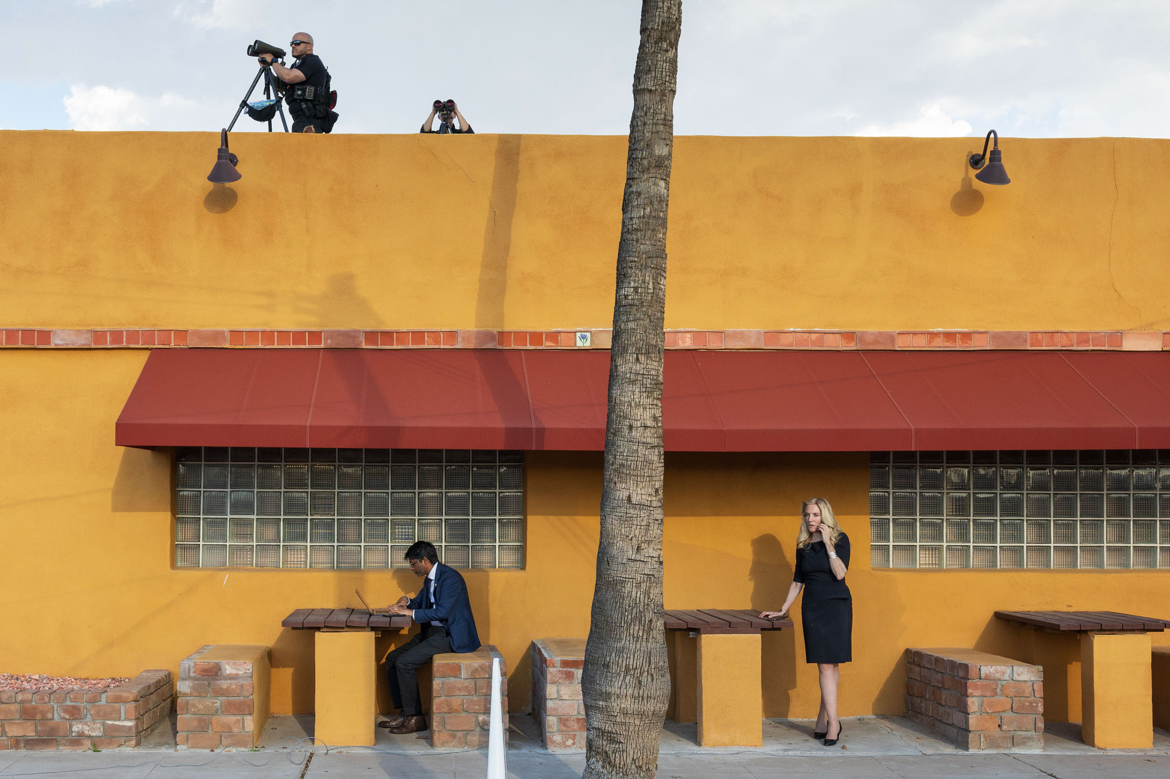 Members of the Secret Service, above, and members of President Joe Biden's campaign staff are seen outside the El Portal restaurant during a campaign event in Phoenix, March 19, 2024. (Tom Brenner/The New York Times)