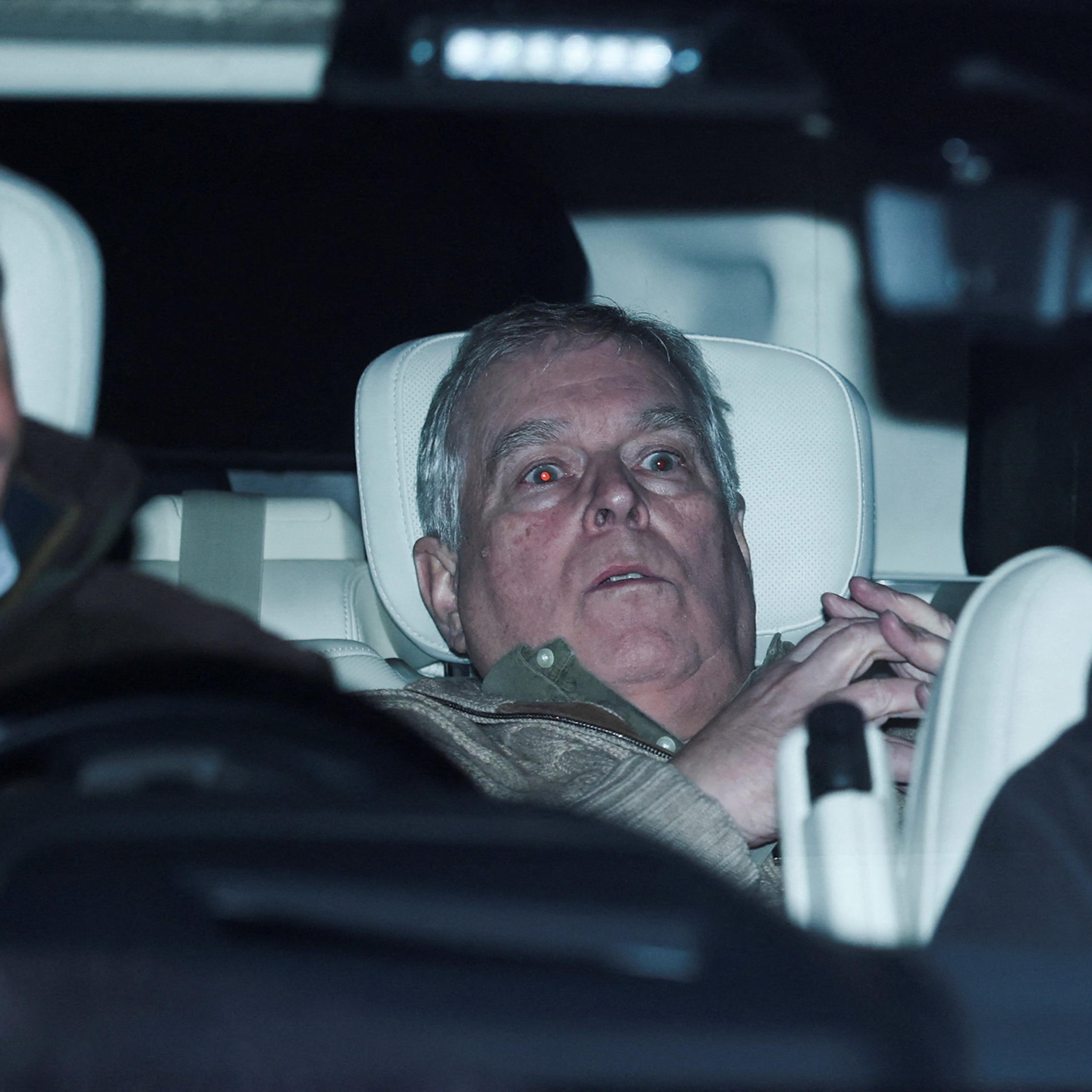 Andrew Mountbatten Windsor in the backseat of a car leaving the police station.