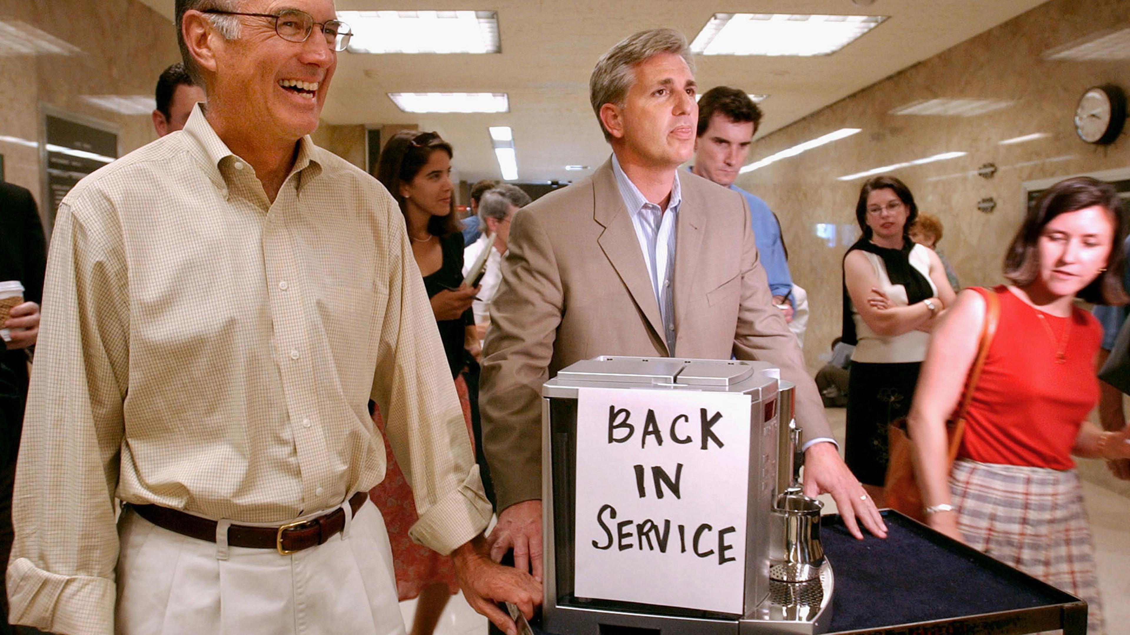 In this July 20, 2004 photo, then-California Assembly Republican Leader Kevin McCarthy, center, and Senate Republican Leader Dick Ackerman, left, wheel a cappuccino machine into the Governor's office at the Capitol in Sacramento. McCarthy, the majority l