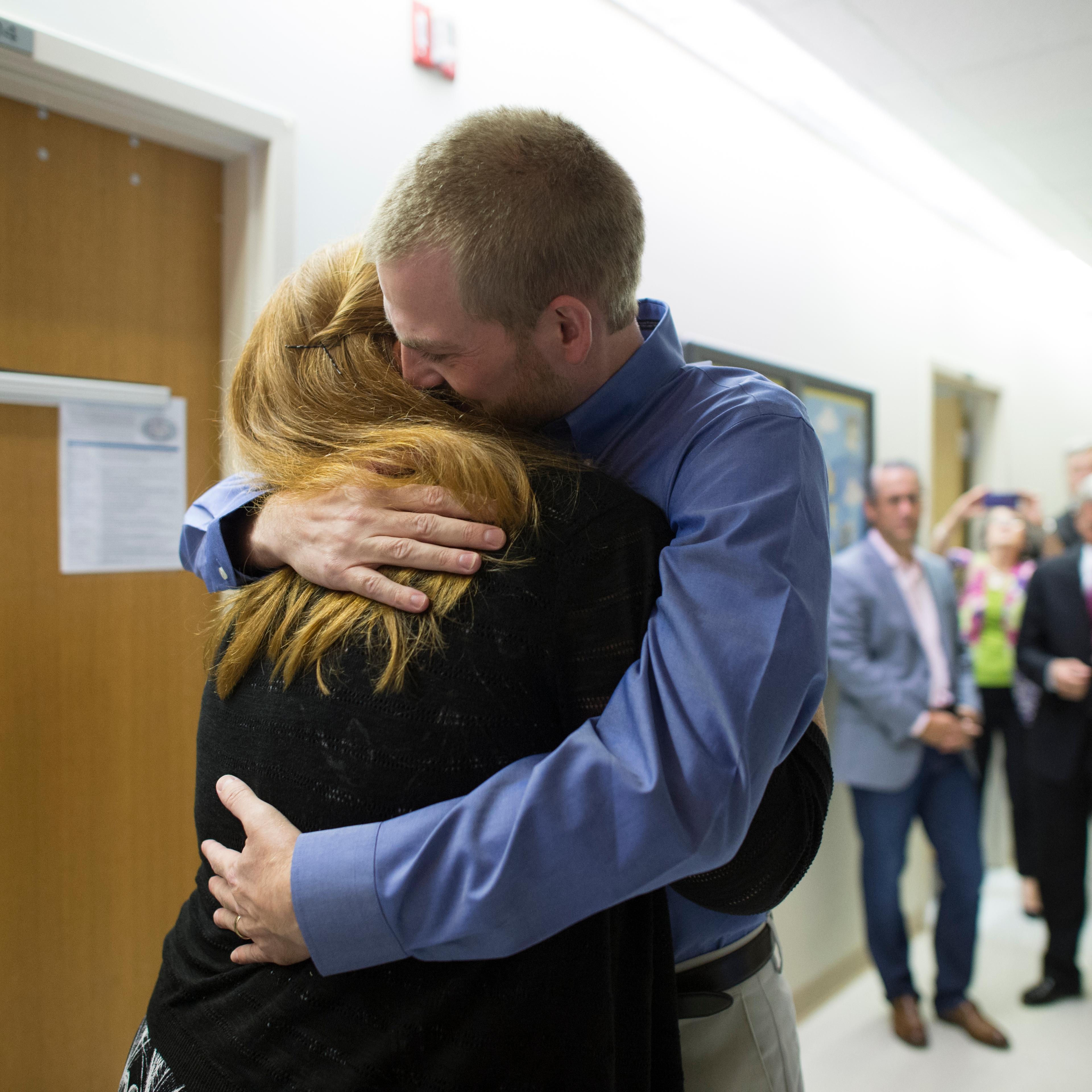 Dr. Kent Brantly hugs his wife Amber after being discharged from Emory University Hospital