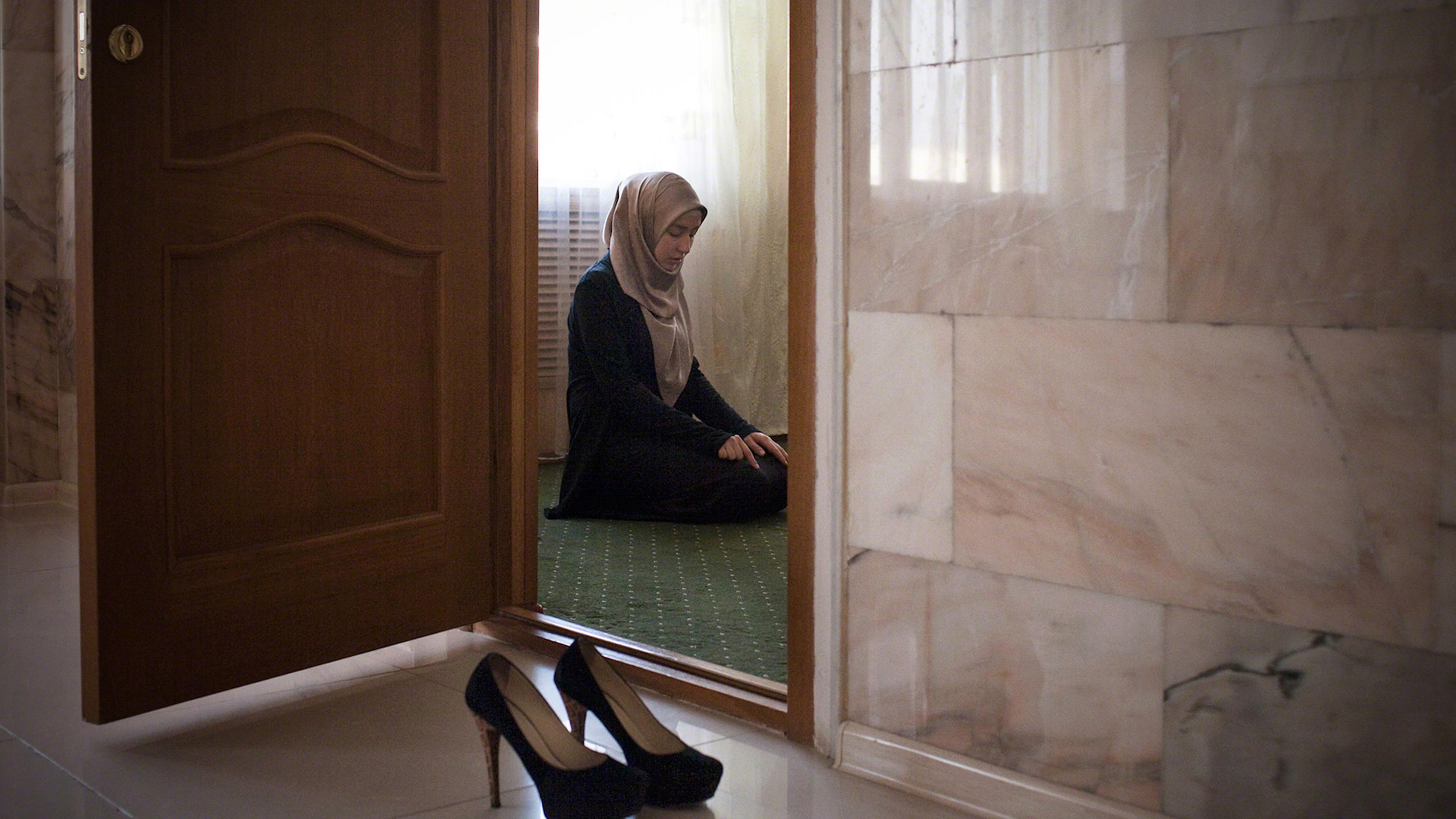 Amina Mutieva , 21, a student at the Islamic University in Grozny prays in a prayer room for women.