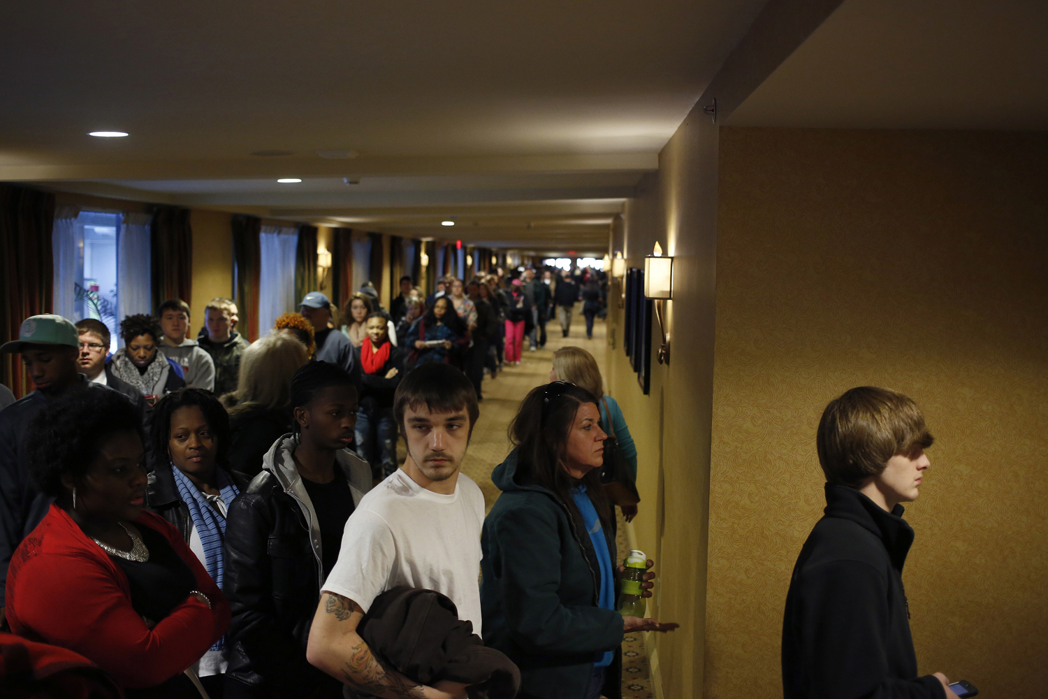 Prospective job applicants wait in line to learn about job openings at the Kentucky Kingdom Amusement Park during a job fair at the nearby Crowne Plaza Hotel in Louisville, Ky., Jan. 4, 2013.