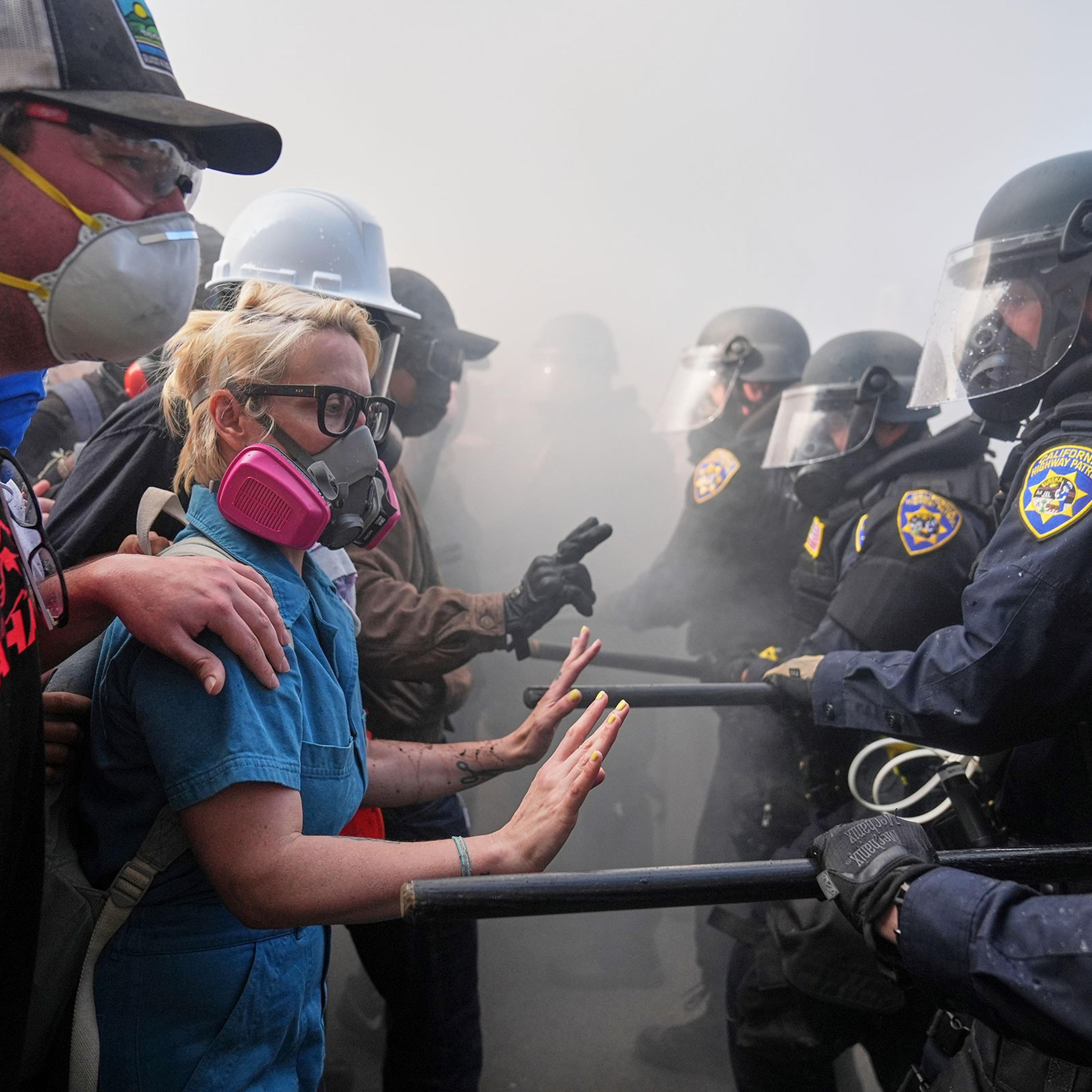Protesters confront police on the 101 Freeway near the Metropolitan Detention Center of downtown Los Angeles, Sunday, June 8, 2025, following last night's immigration raid protest.