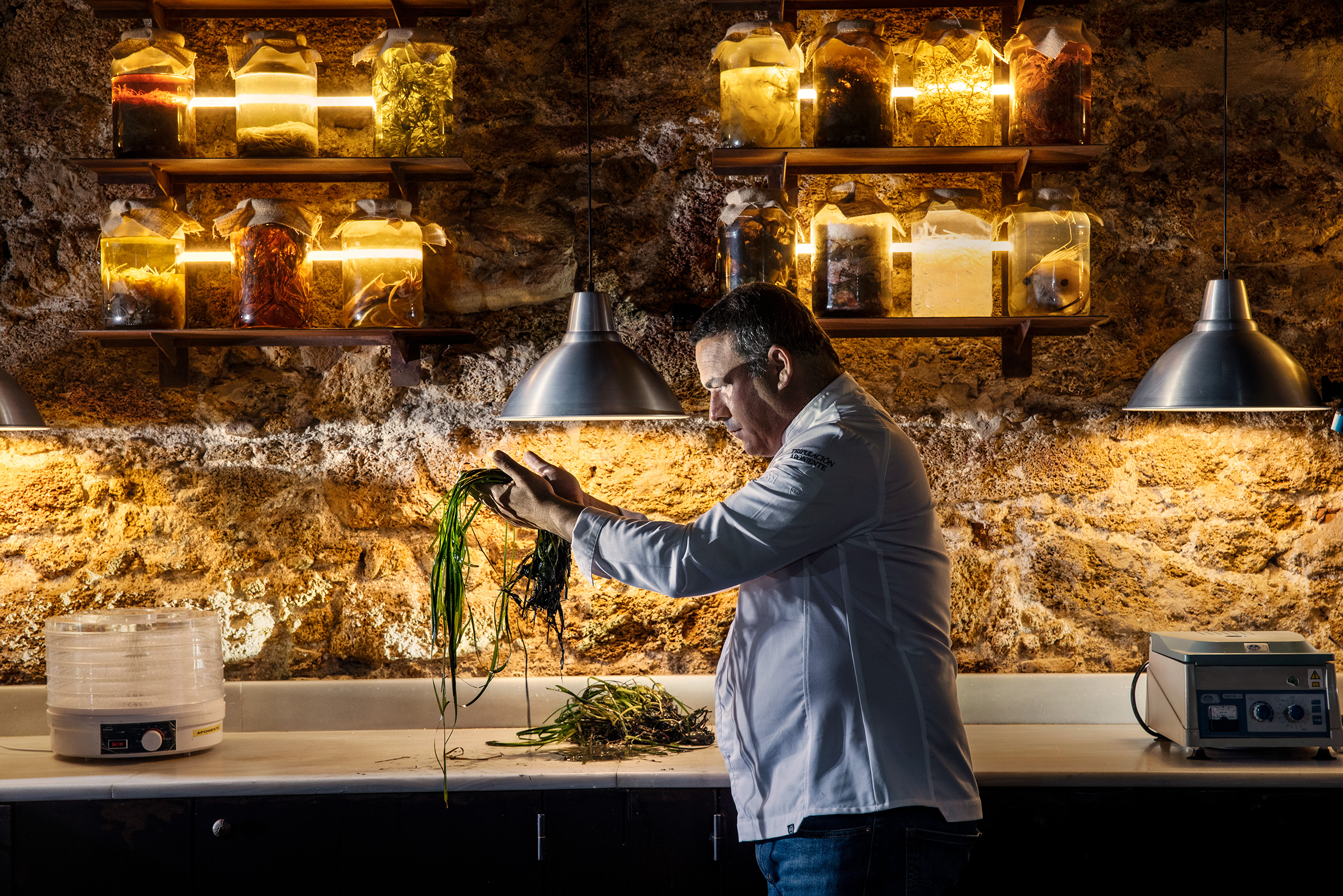Chef Ángel León holding seagrass at his Michelin three-star seafood restaurant, Aponiente, in El Puerto de Santa María, Spain