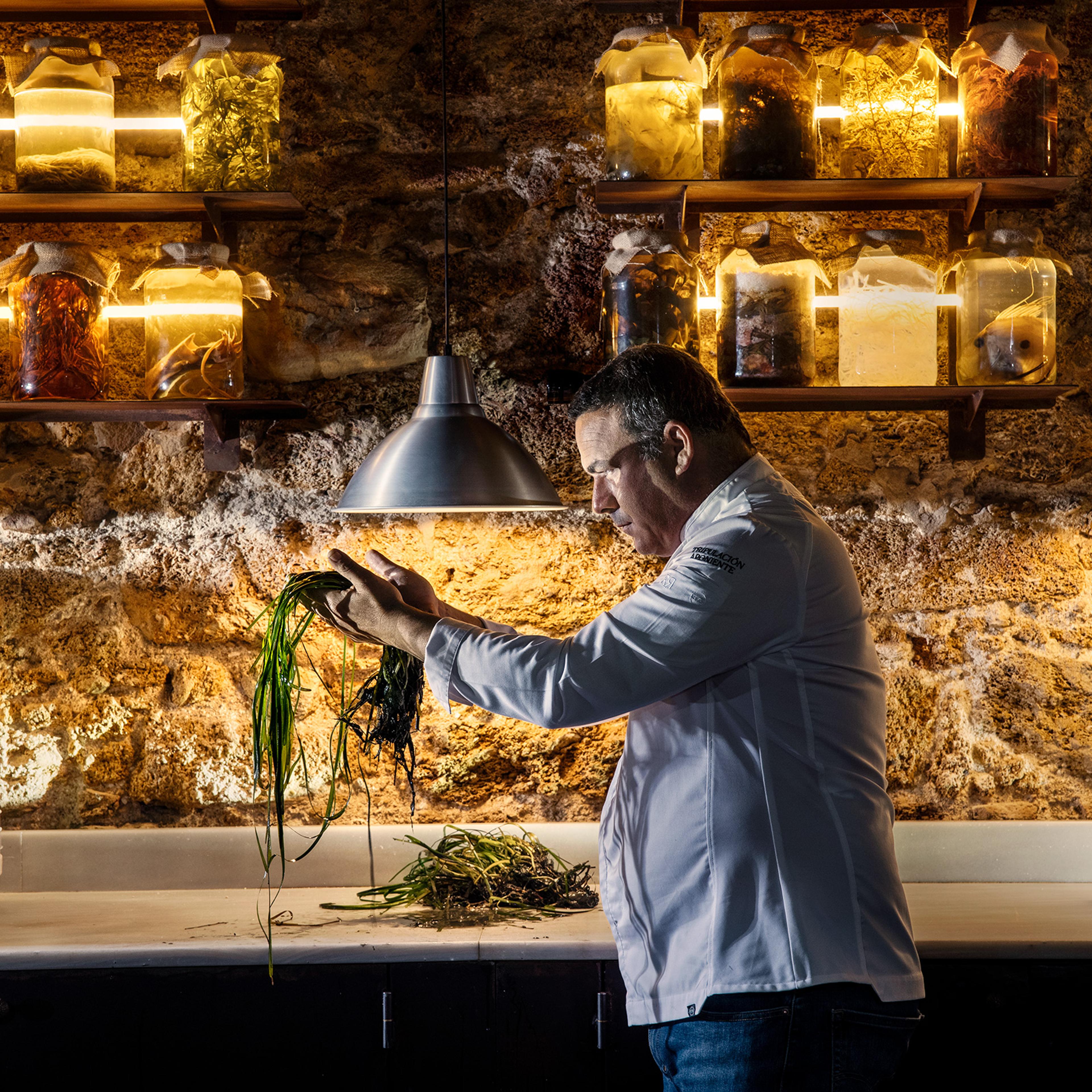 Chef Ángel León holding seagrass at his Michelin three-star seafood restaurant, Aponiente, in El Puerto de Santa María, Spain