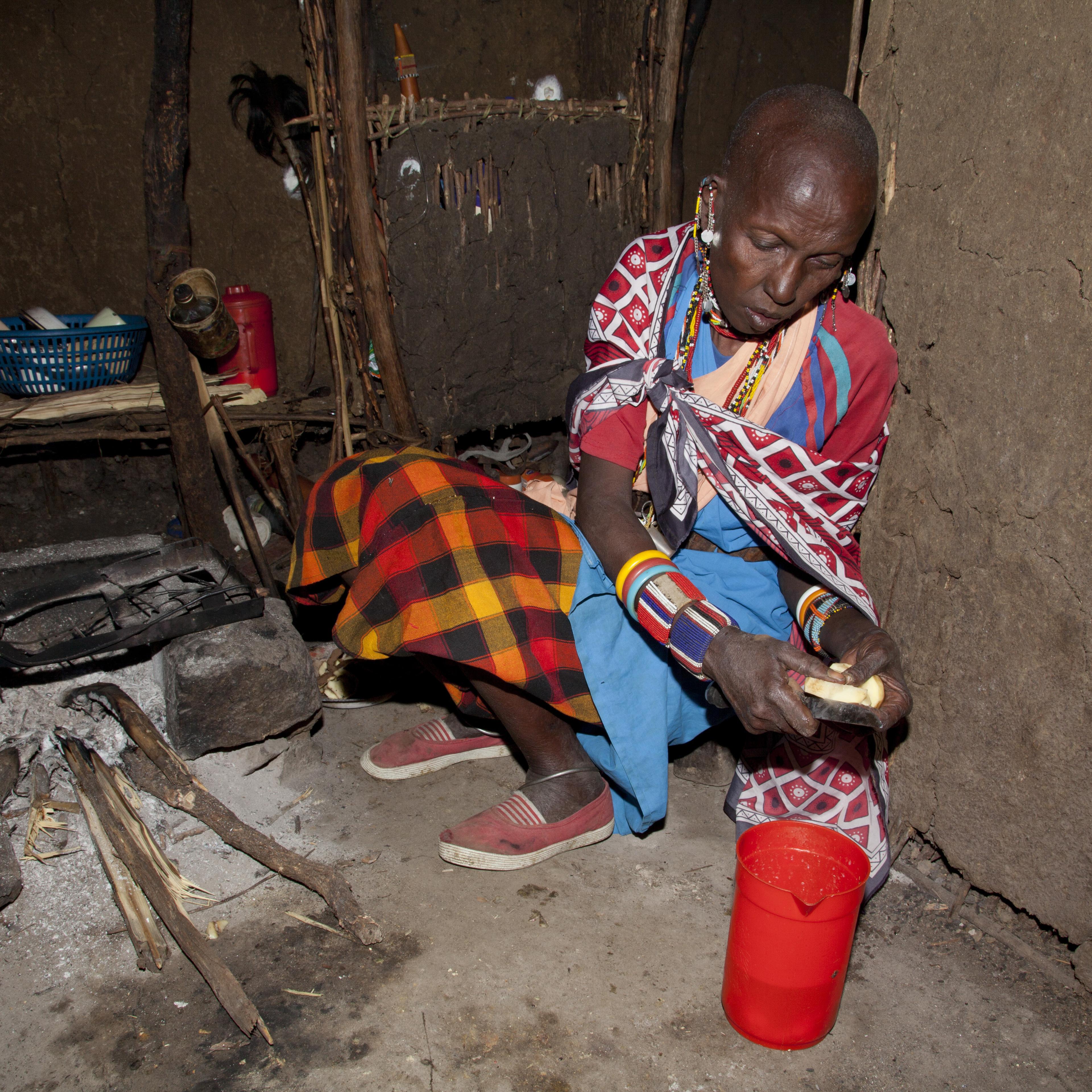 Masai wife of elder chief cooking in her hut in the village of Oliolomutia , next to the Masai Mara Nature Reserve, Kenya