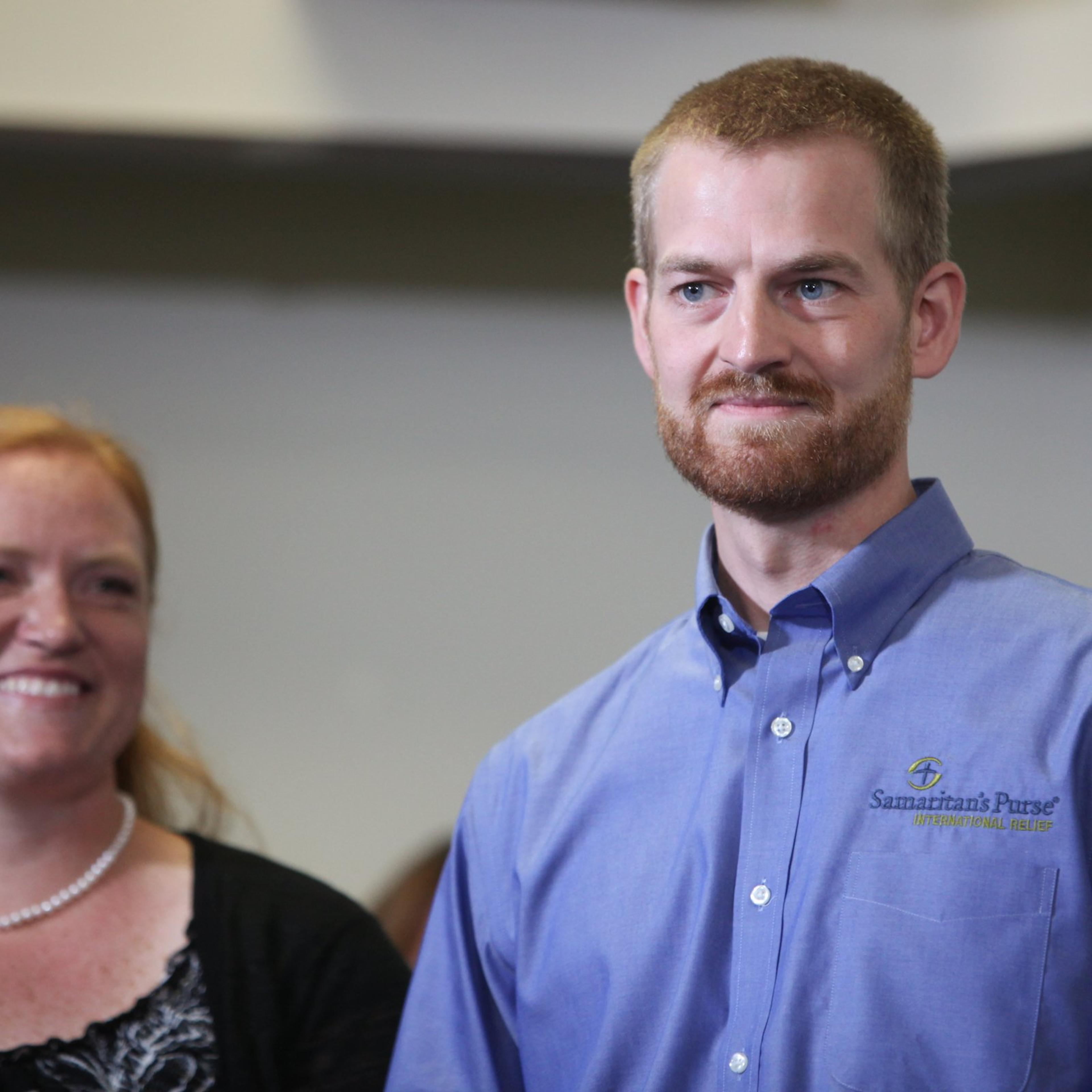 Dr. Kent Brantly an Ebola patient at Emory Hospital, stands with his wife, Amber Brantly, during a press conference announcing his release from the hospital on August 21, 2014 in Atlanta.