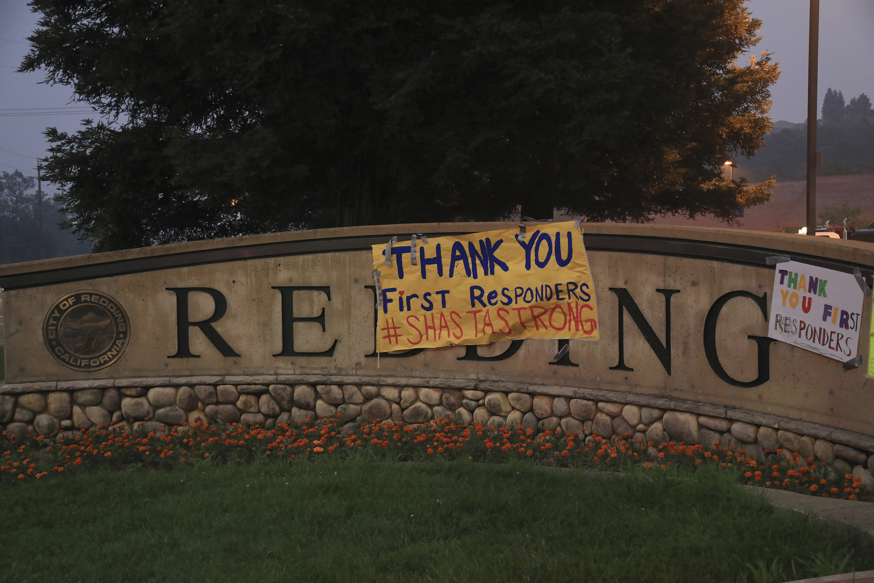 Signs of encouragement for first responders is hung on a city in Redding, Calif.