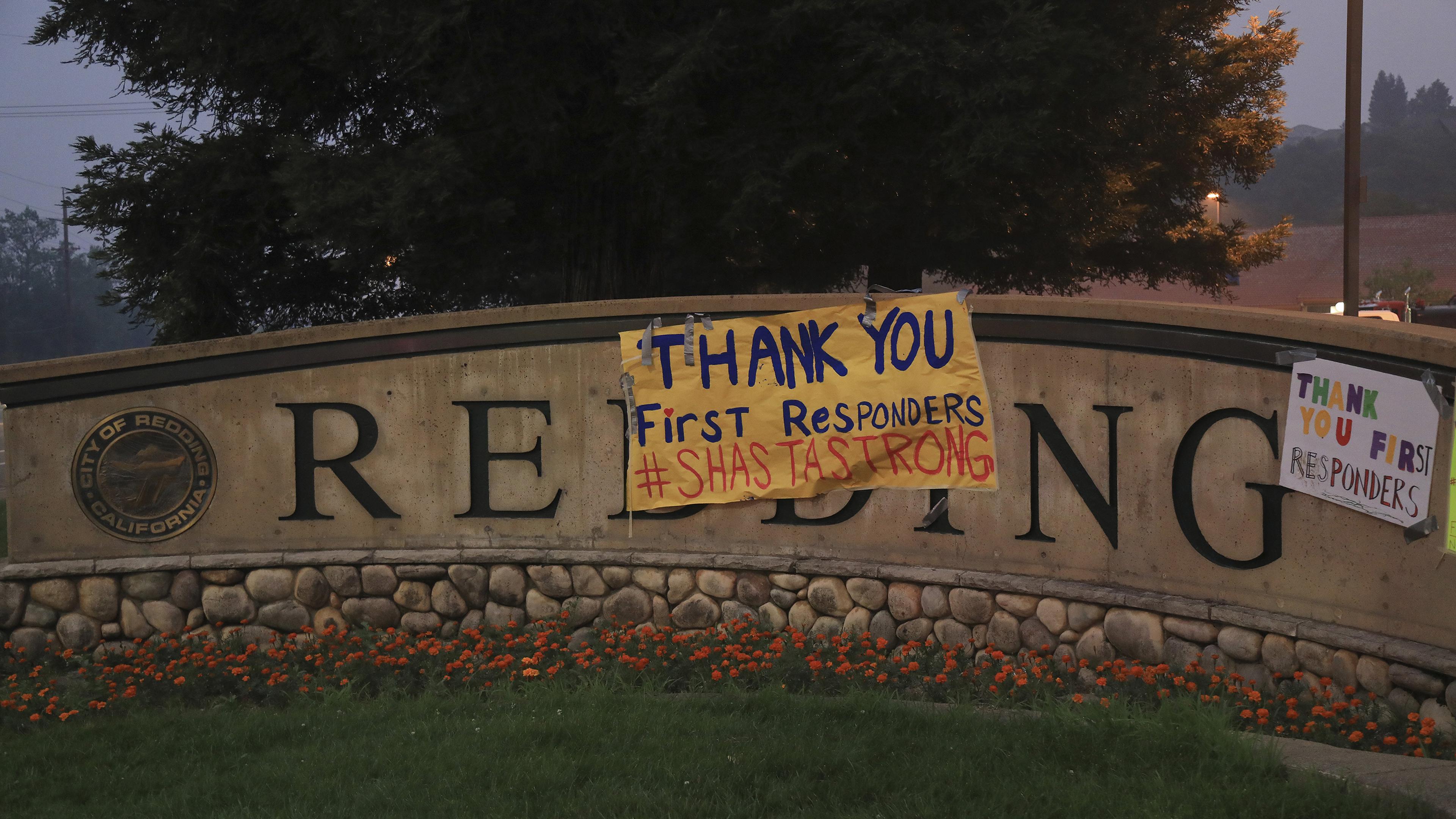 Signs of encouragement for first responders is hung on a city in Redding, Calif.