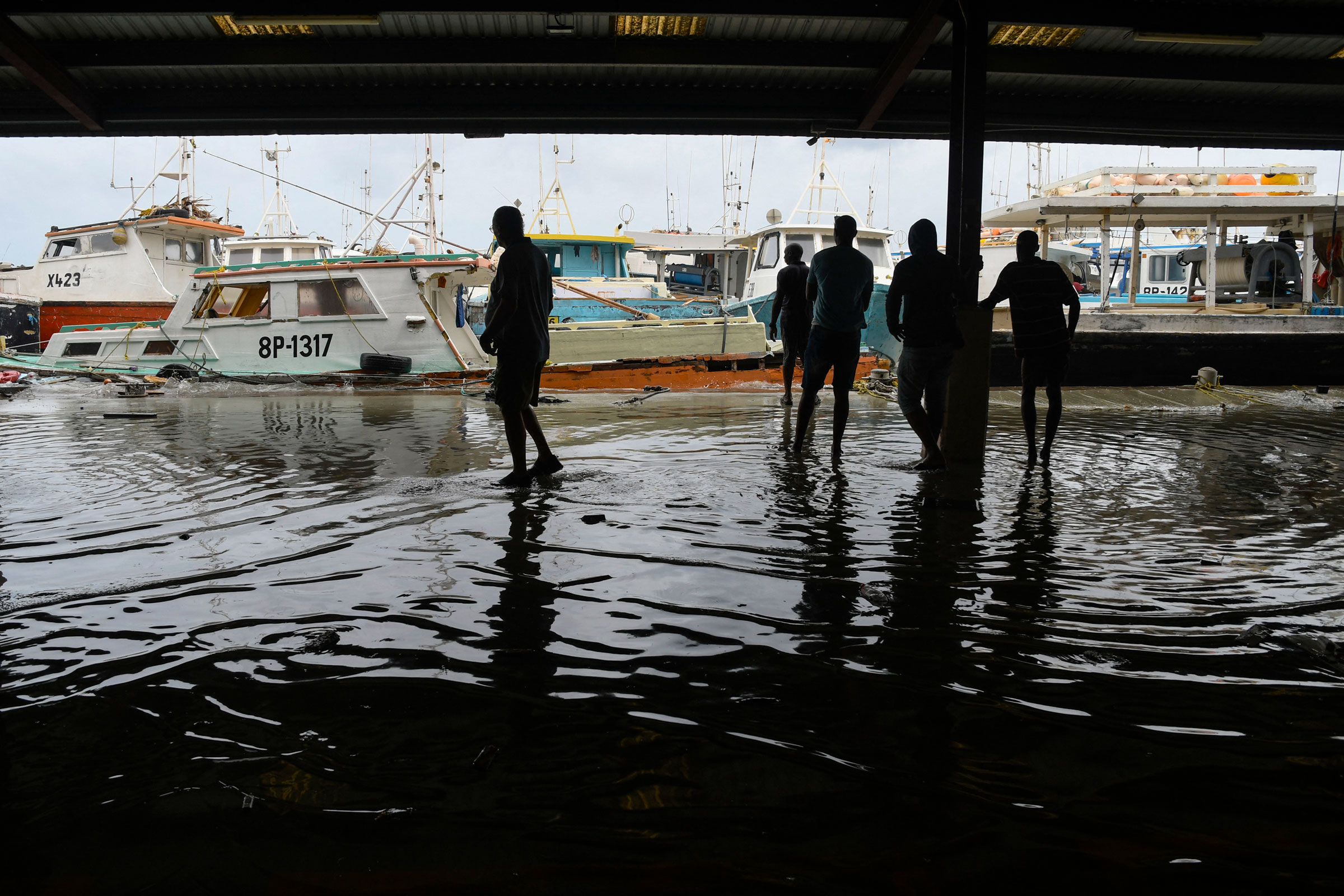 Fishermen watch their damaged fishing boats after the passage of Hurricane Beryl at the Bridgetown Fish Market, Bridgetown, Barbados, July 1, 2024.