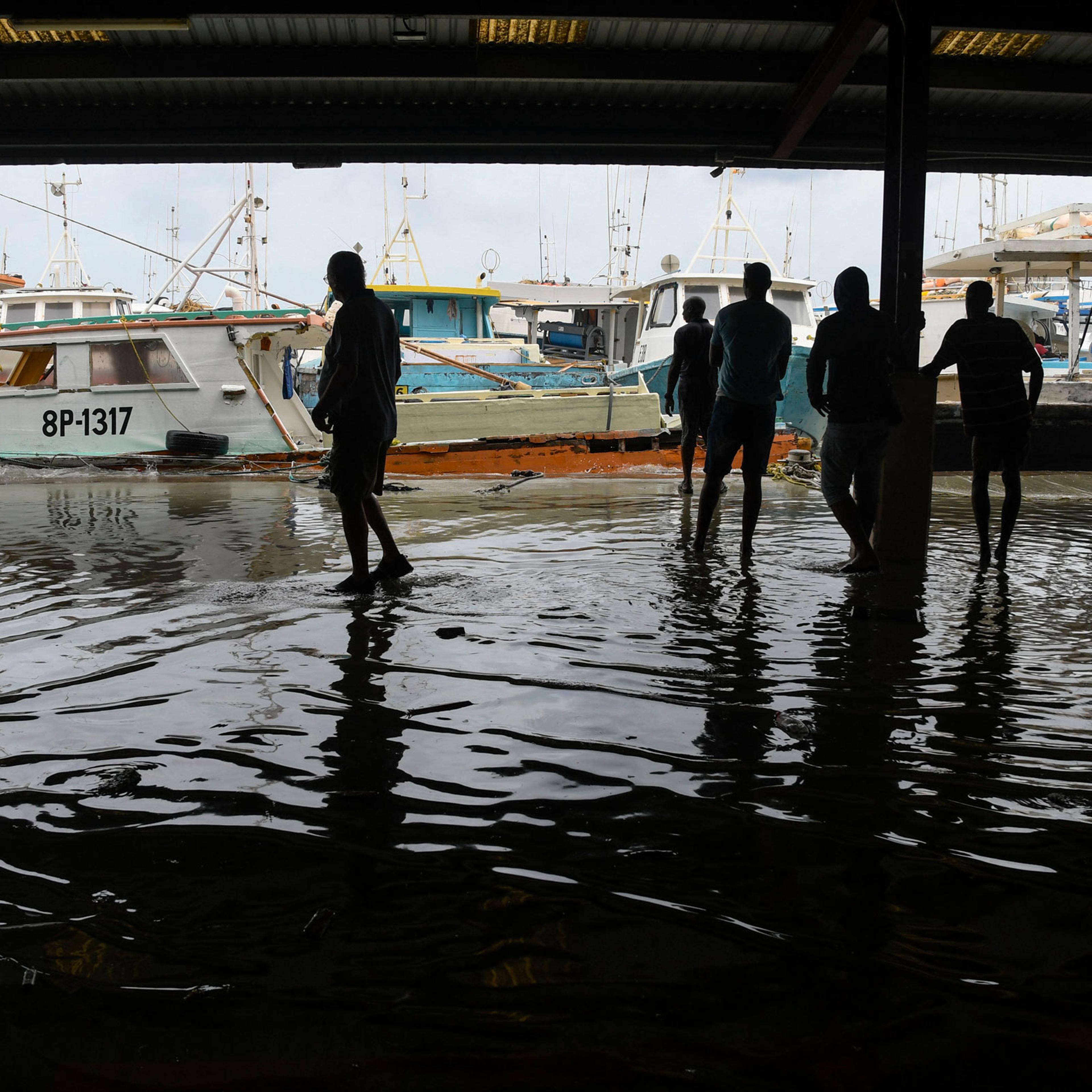 Fishermen watch their damaged fishing boats after the passage of Hurricane Beryl at the Bridgetown Fish Market, Bridgetown, Barbados, July 1, 2024.