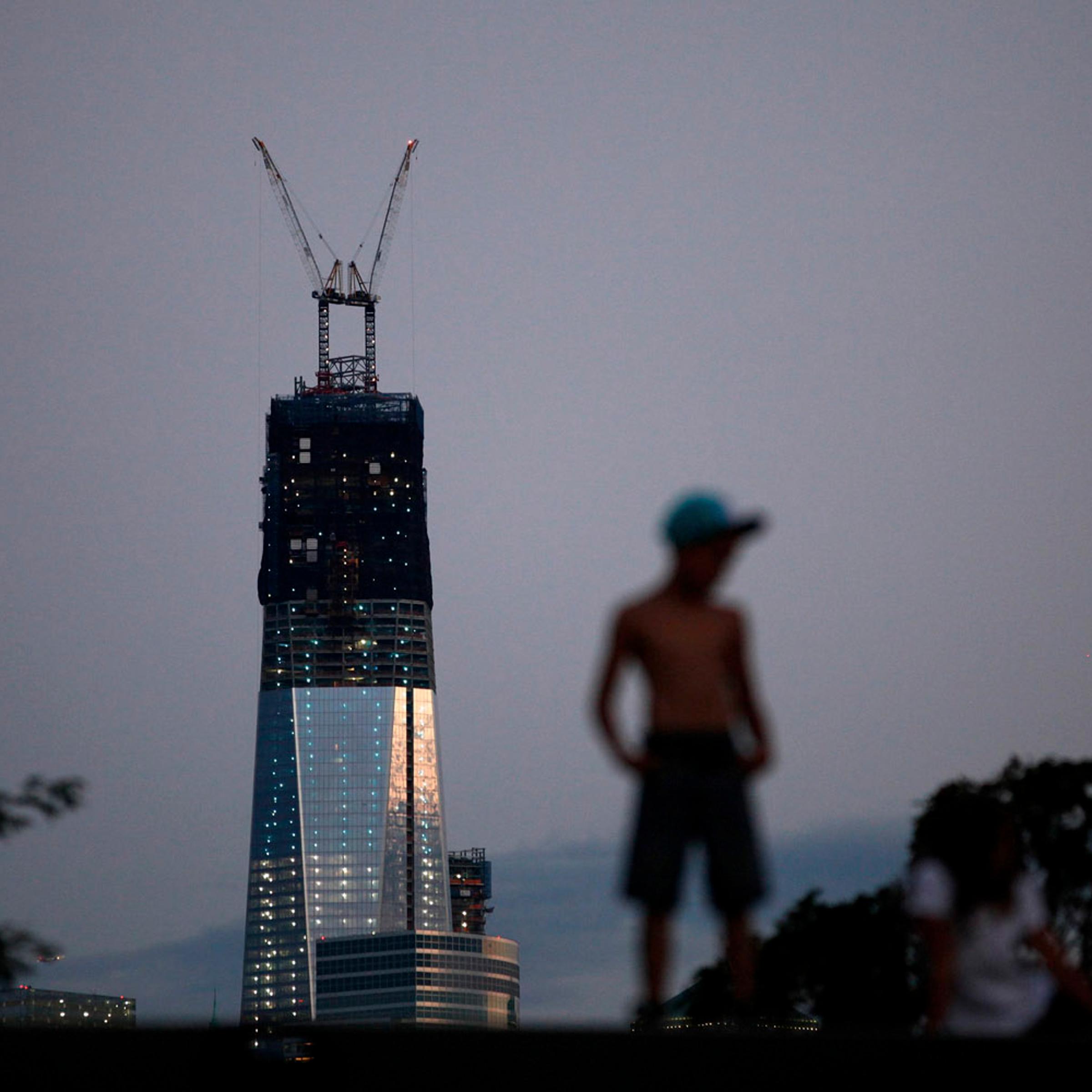 Sept. 9, 2012. One World Trade Center stands tall on the skyline of New York's Lower Manhattan as a boy stands on a pier in Hoboken, N.J.
